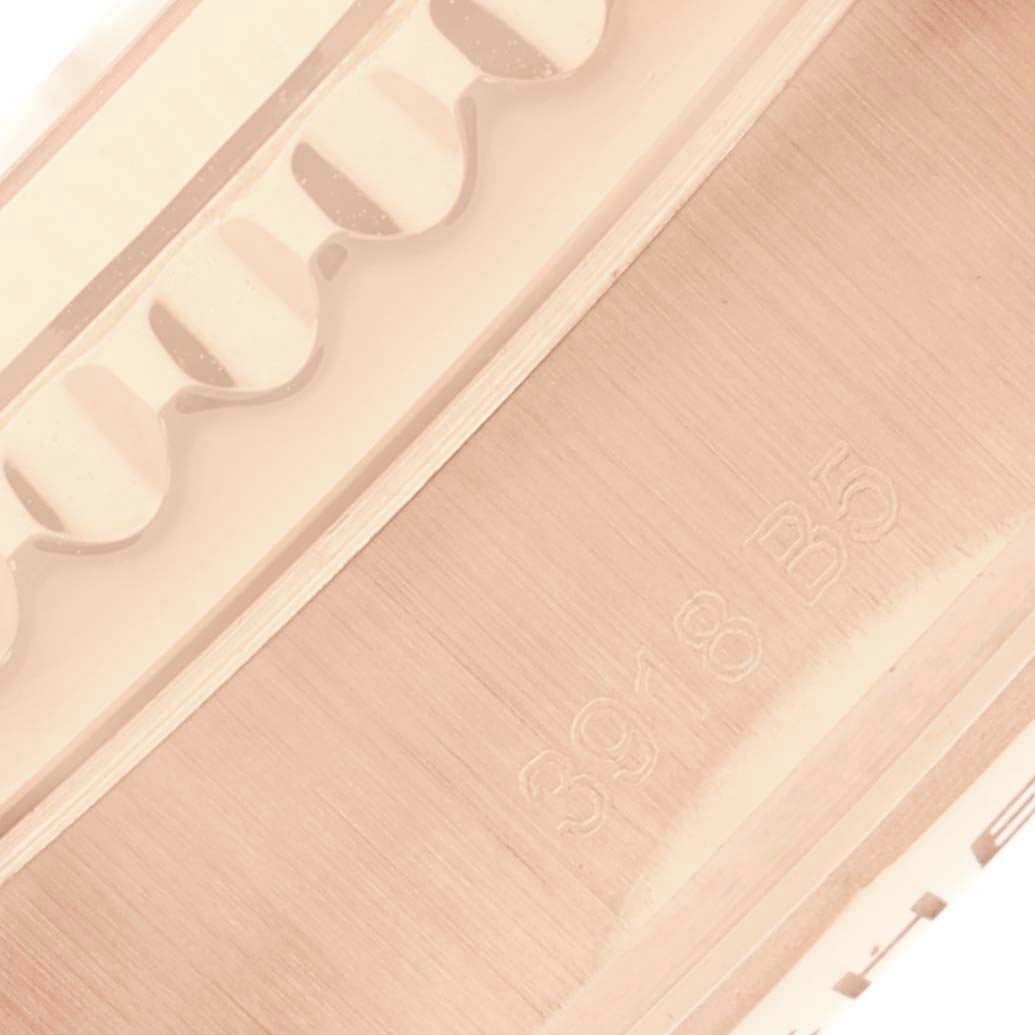 The image shows a close-up of the engraved side and crenulated bezel of a Breitling Navitimer watch.