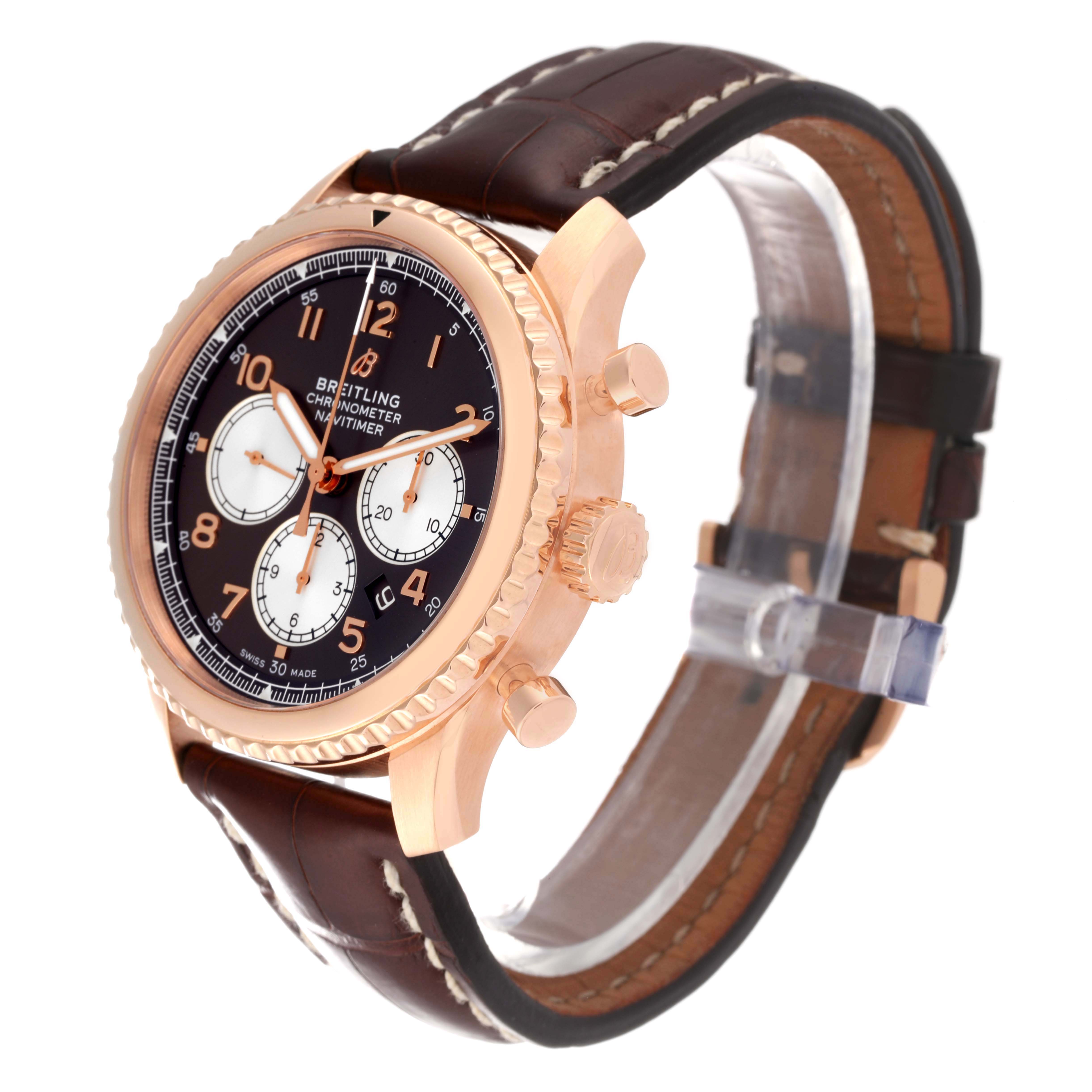 The Breitling Navitimer watch is shown at a three-quarter angle, highlighting the case, dial, pushers, crown, and leather strap.