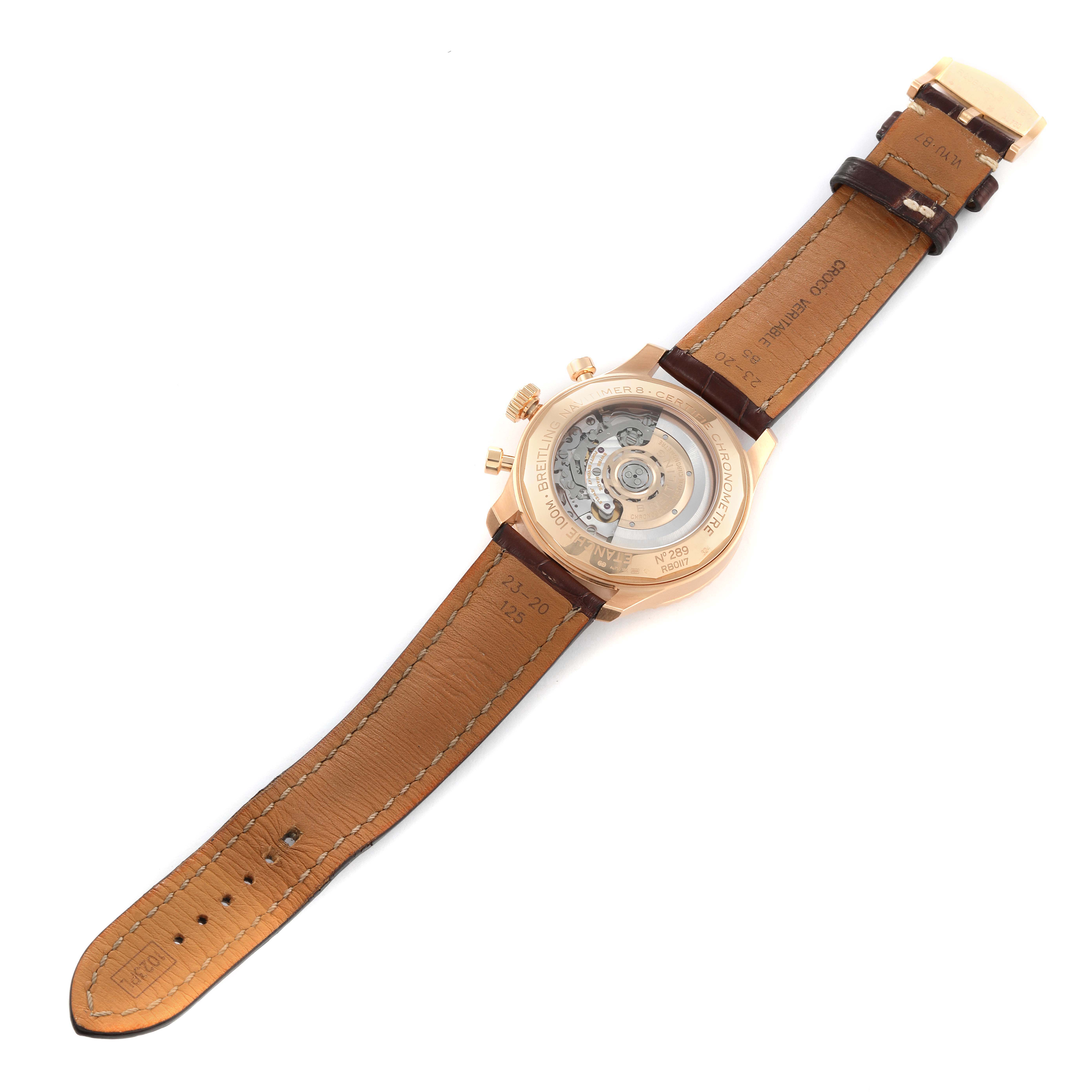 This image shows the underside of a Breitling Navitimer watch, highlighting the case back and leather strap.