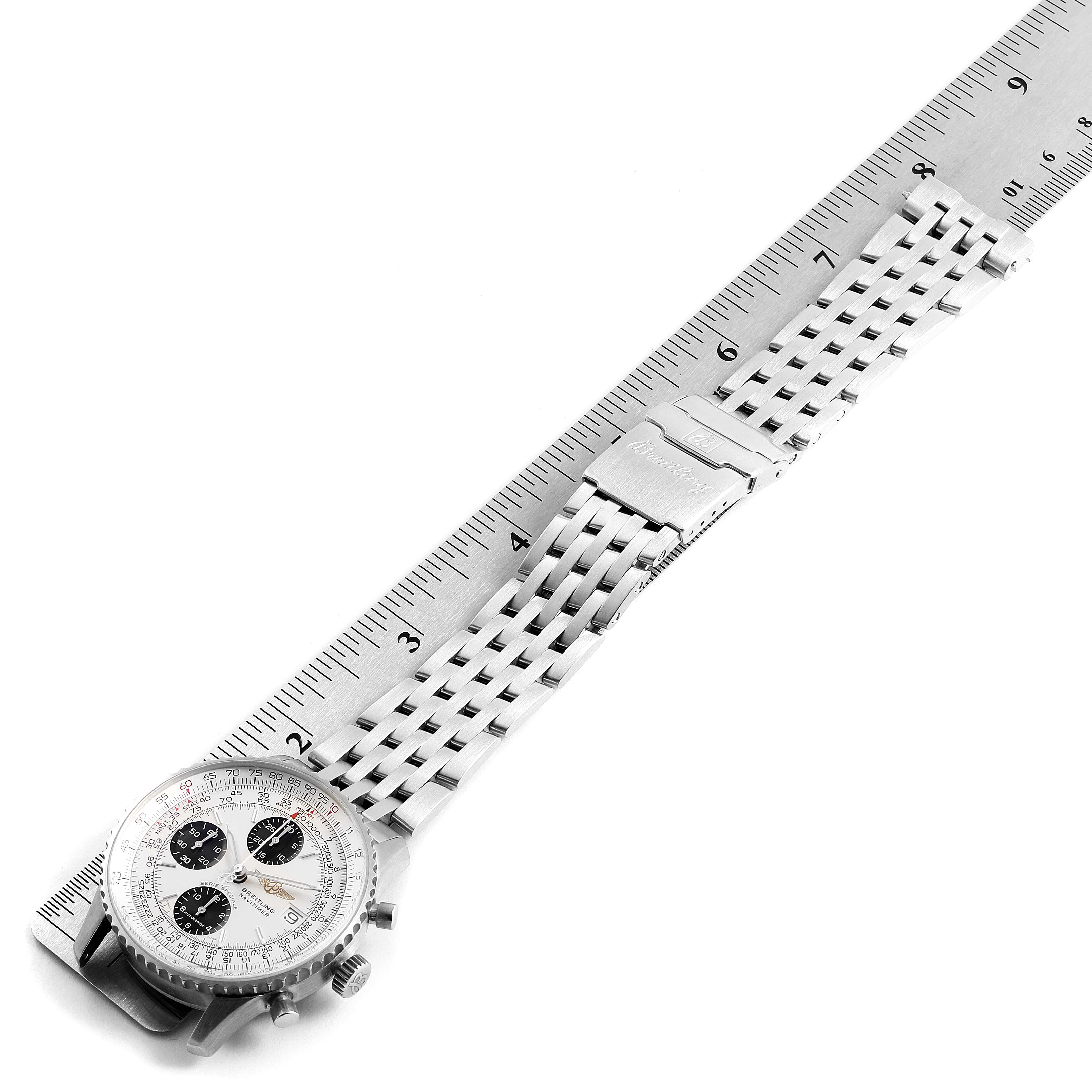 The image shows a Breitling Navitimer A13330 Men's Stainless Steel Silver Dial A13330 Men's Stainless Steel Silver Dial watch laid flat next to a ruler, displaying its face and stainless steel bracelet.