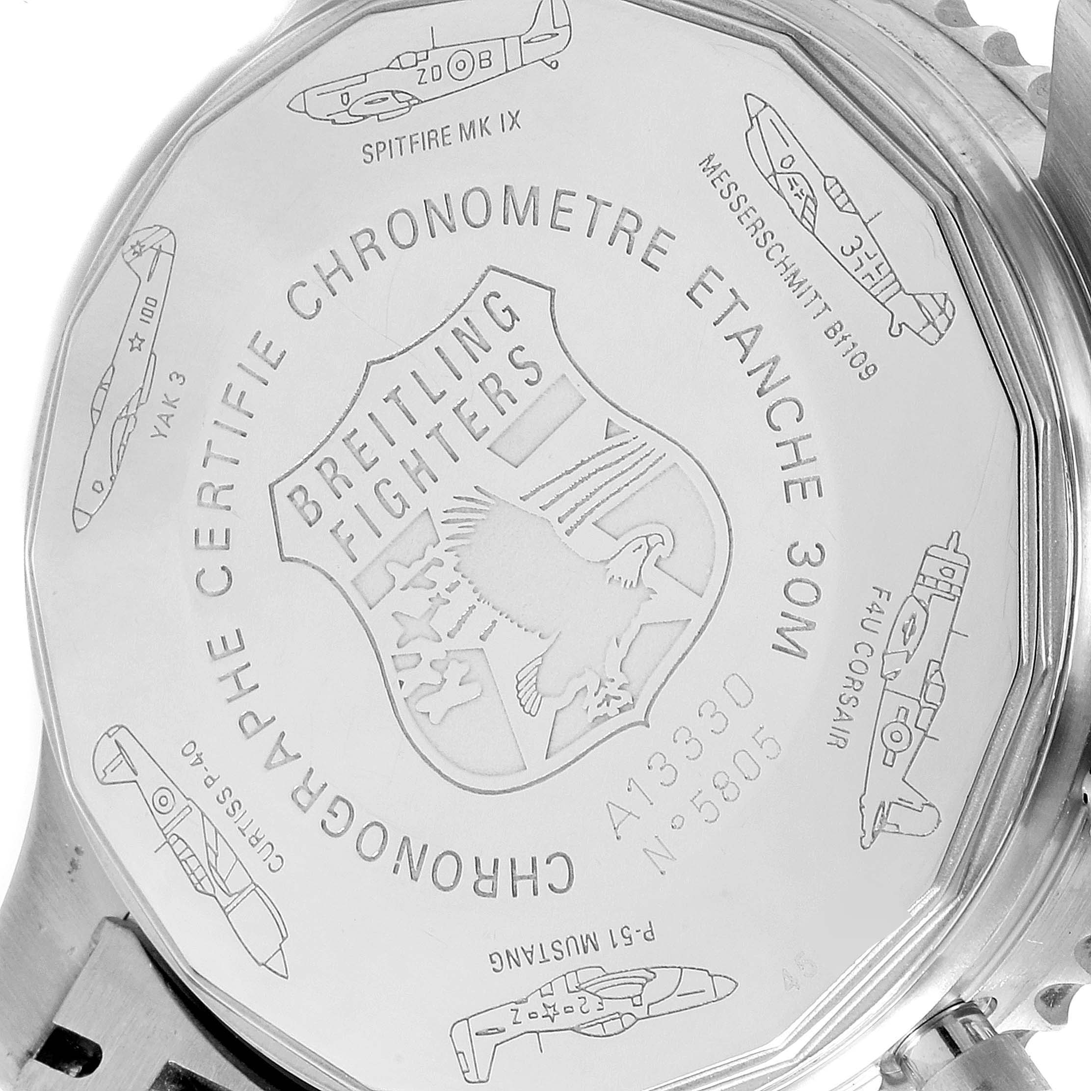 This image shows the back case of a Breitling Navitimer A13330 Men's Stainless Steel Silver Dial A13330 Men's Stainless Steel Silver Dial watch, featuring engraved aircraft designs and the Breitling Fighters logo.