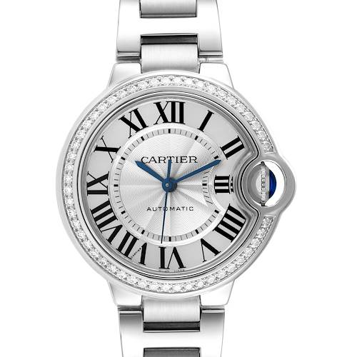 The Cartier Ballon Bleu watch is shown from a front angle, highlighting the diamond bezel and blue cabochon crown.