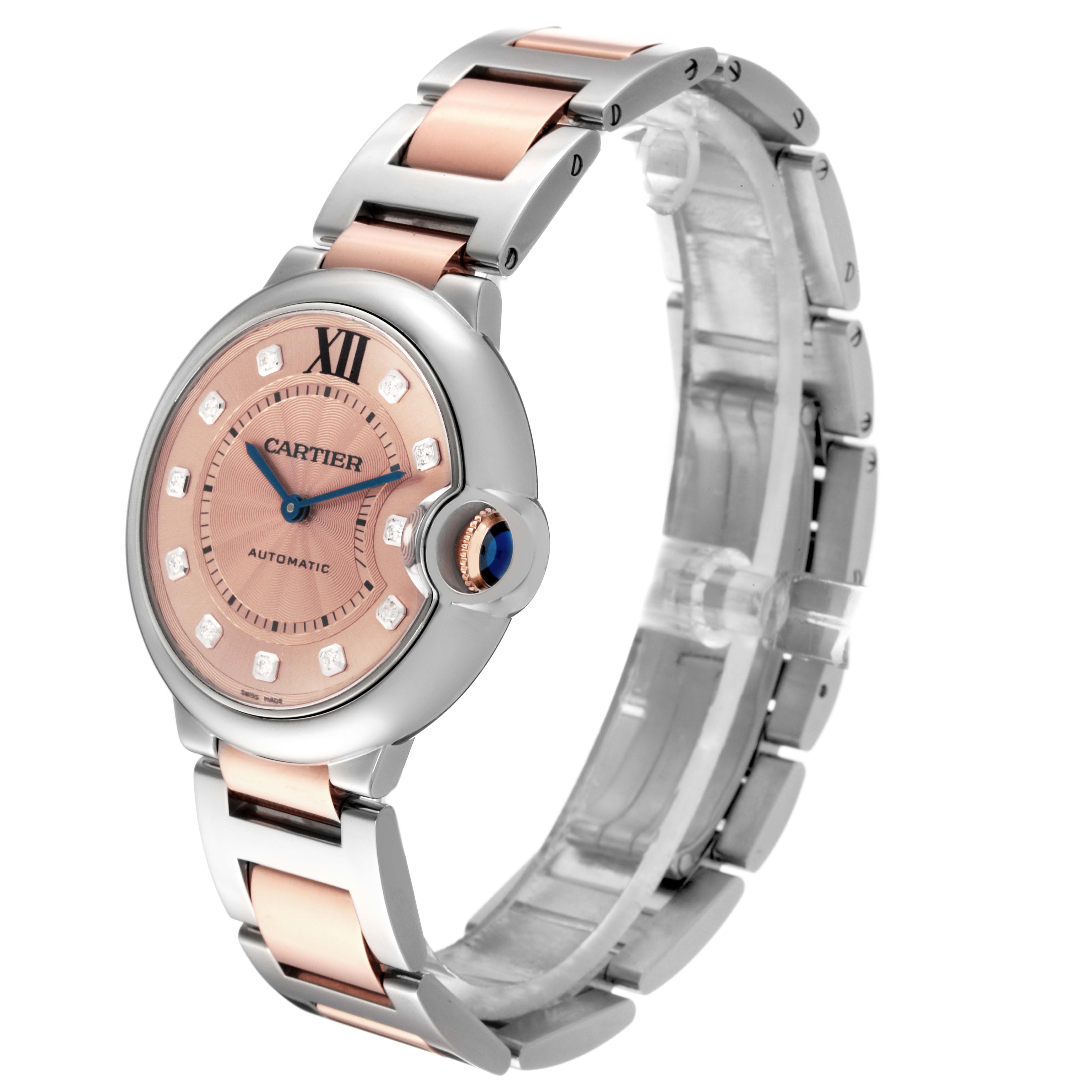 The Cartier Ballon Bleu WE902054 Women's Steel and Gold (two tone) Pink Dial WE902054 Women's Steel and Gold (two tone) Pink Dial watch is shown at an angle highlighting the face, bracelet, and distinctive crown.
