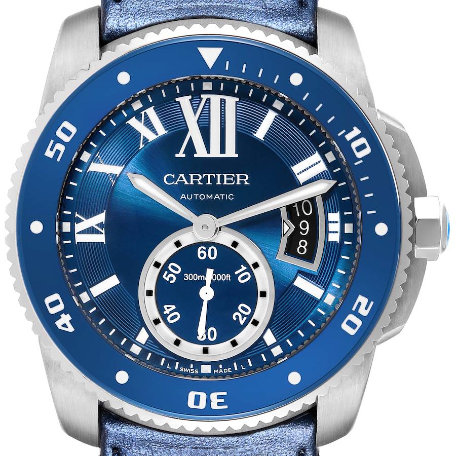 The image shows a front view of the Calibre de Cartier watch, highlighting its blue dial, bezel, and date display.