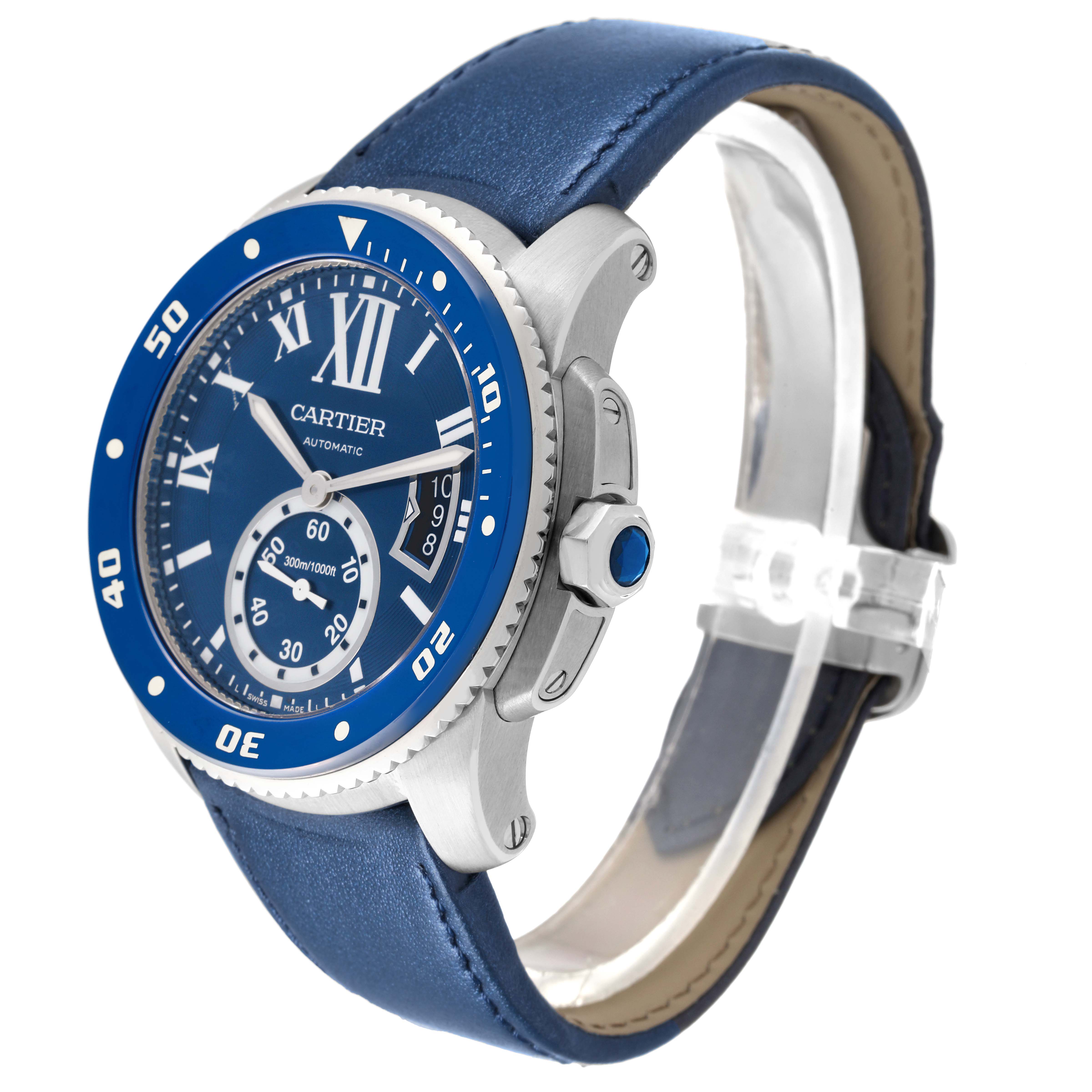 The Calibre de Cartier watch is shown at a three-quarter angle highlighting the bezel, crown, dial, and blue leather strap.