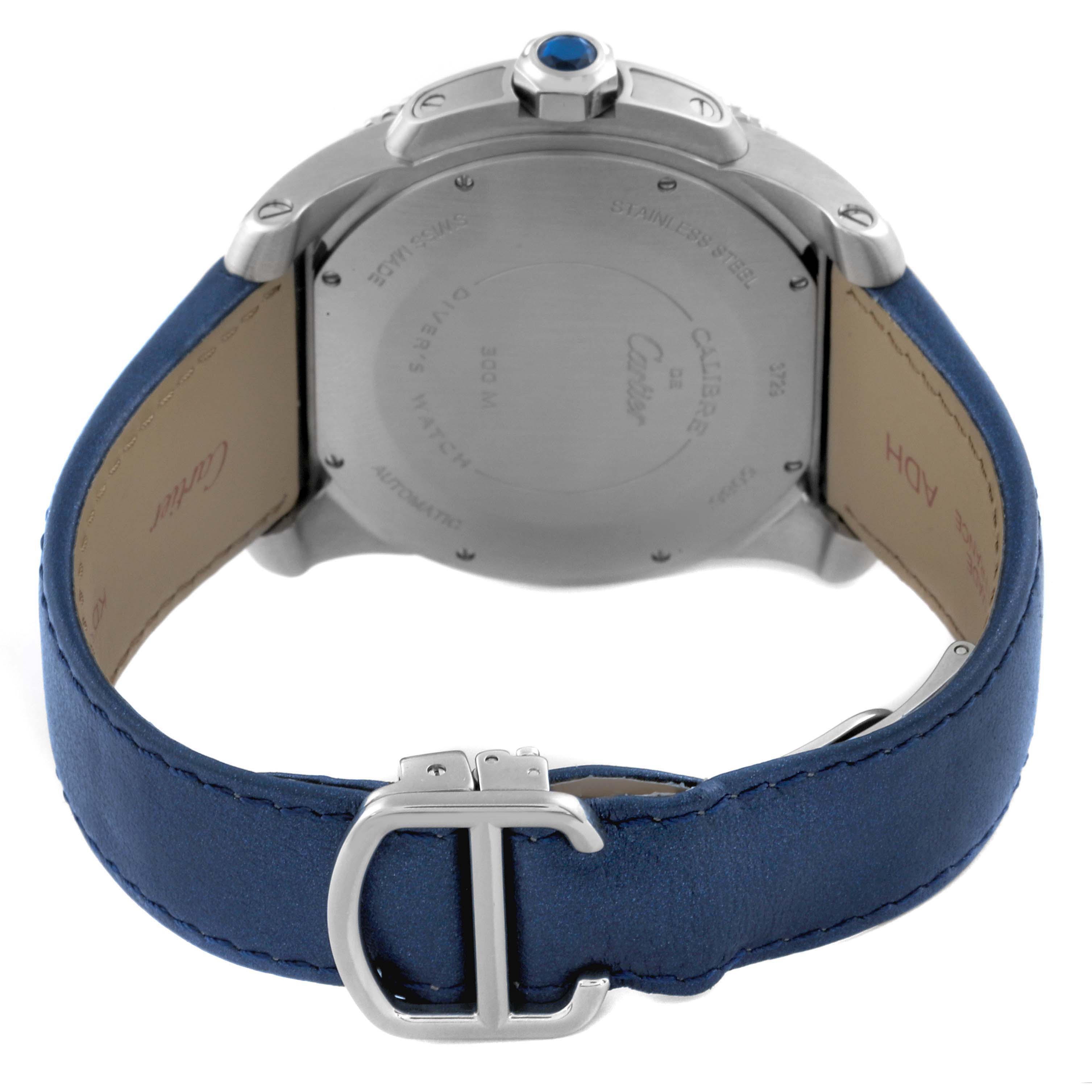 The image shows the back and side of a Calibre de Cartier watch, highlighting the case back, crown, and blue leather strap.