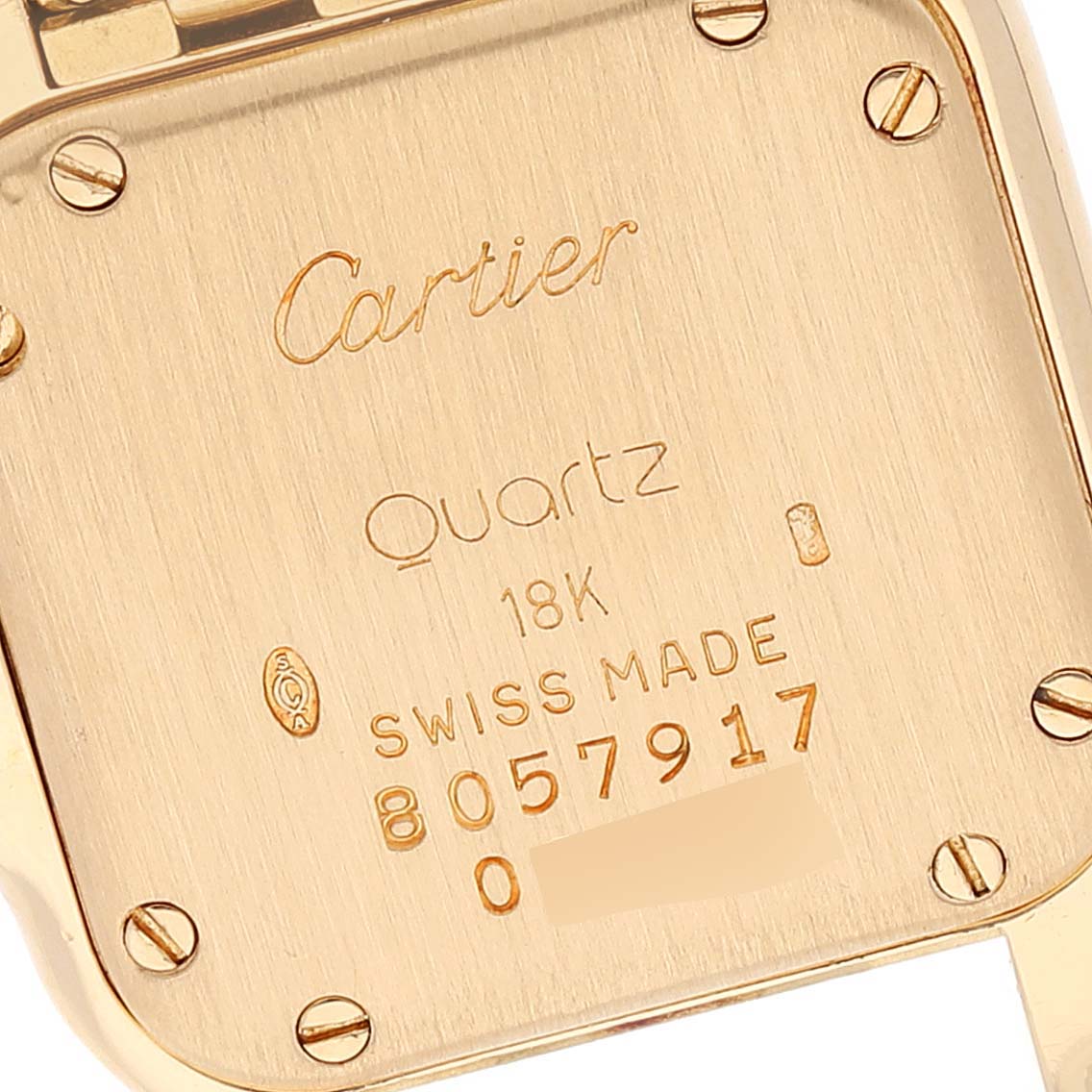 This image shows the back case of a Cartier Panthere W25022B9 Women's Yellow Gold Silver Dial W25022B9 Women's Yellow Gold Silver Dial watch, displaying inscriptions and serial numbers.
