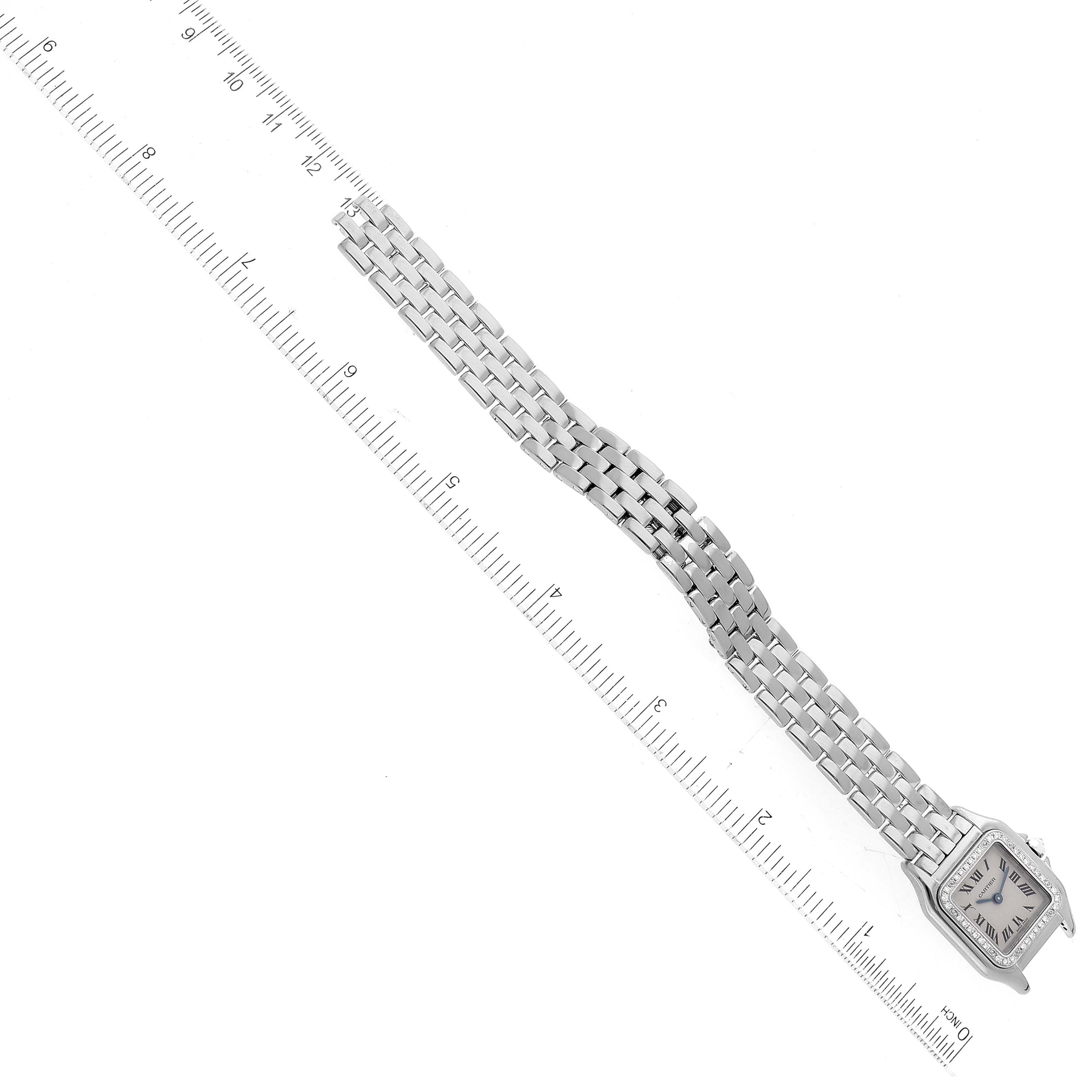 This image shows the Cartier Panthere WF3091F3 Women's White Gold Silver Dial WF3091F3 Women's White Gold Silver Dial model watch laid flat with a ruler for size reference.