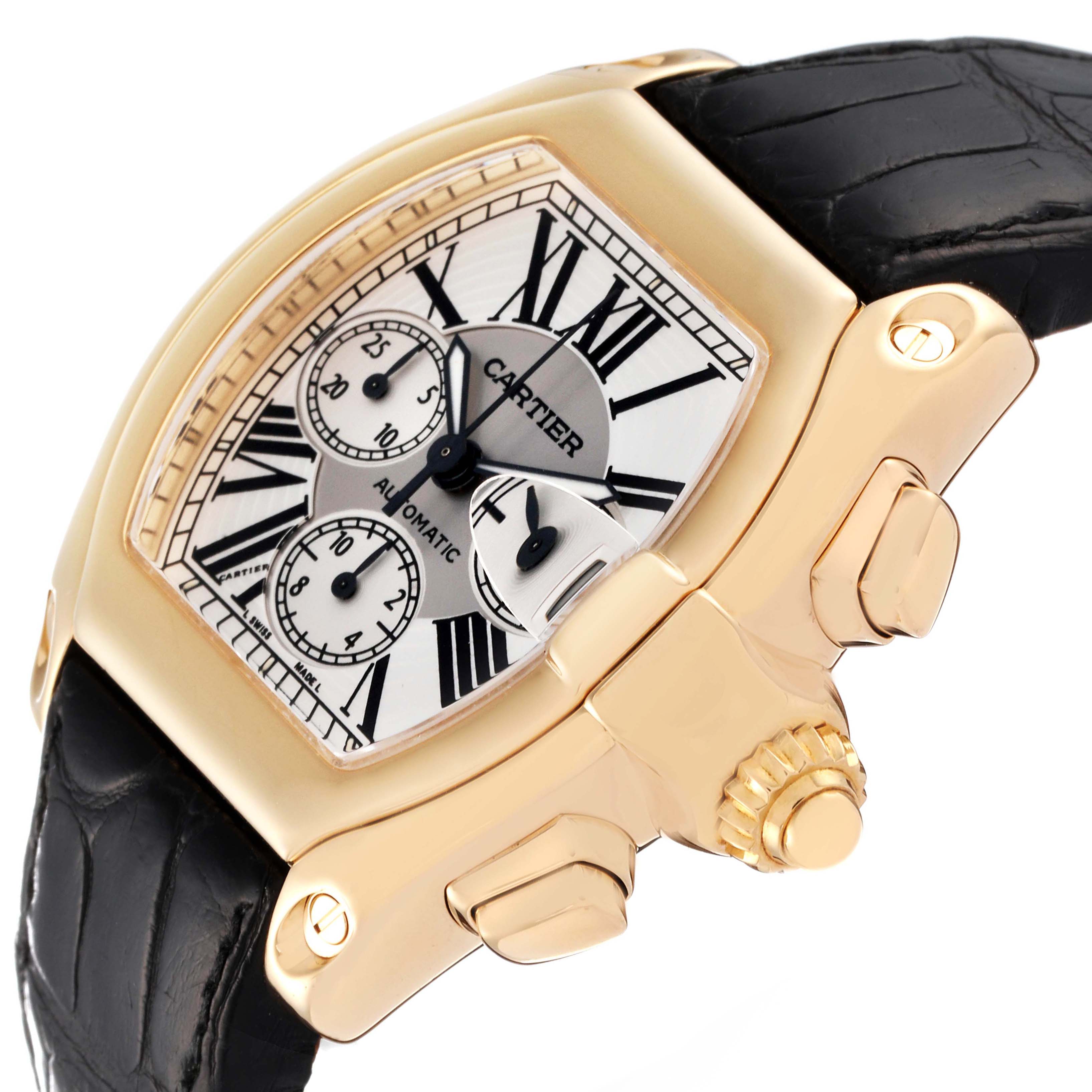 The Cartier Roadster W62021Y3 Men's Yellow Gold Silver Dial W62021Y3 Men's Yellow Gold Silver Dial watch is shown at an angle highlighting the crown, chronograph subdials, and a black leather strap.