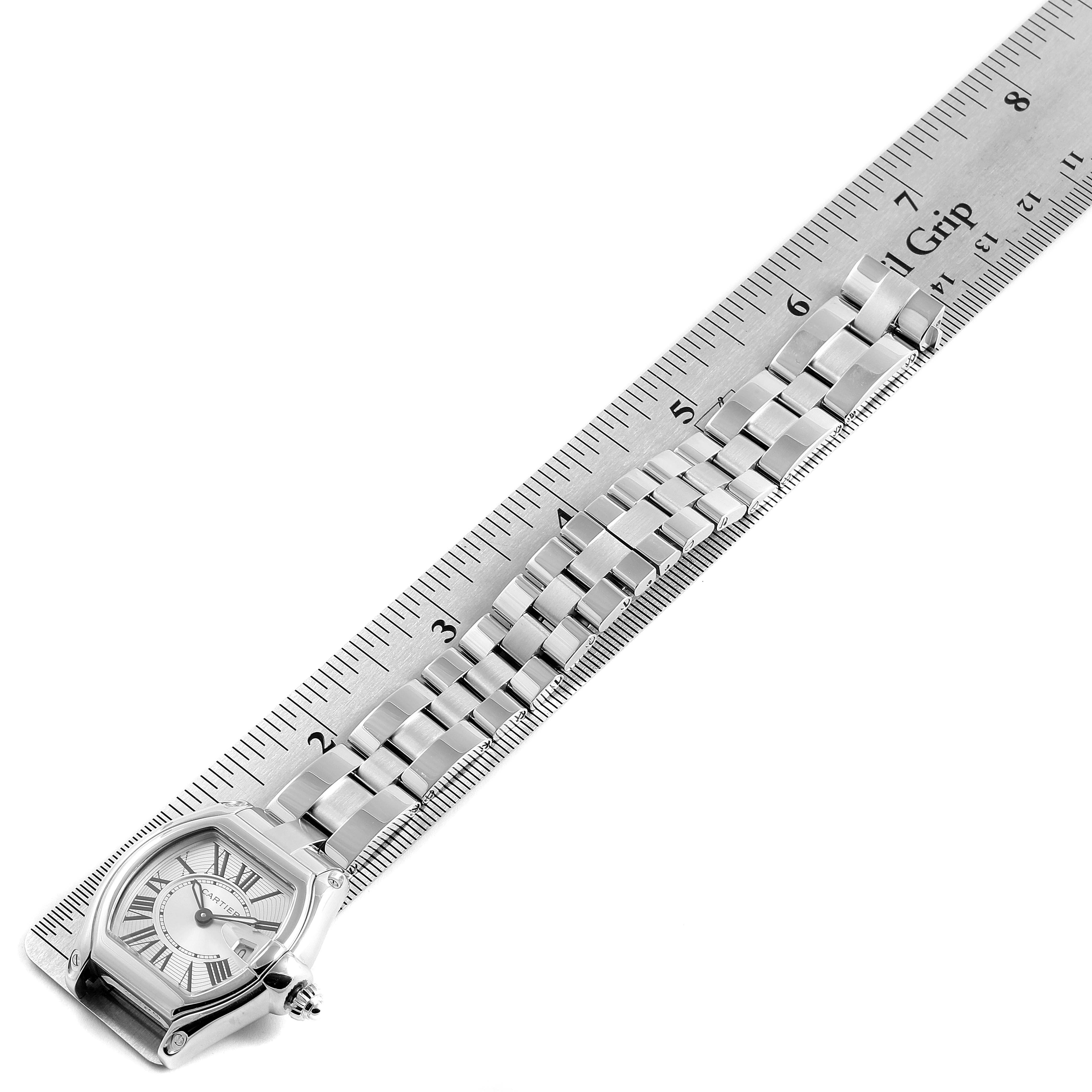 This image shows a Cartier Roadster W62016V3 Women's Stainless Steel Silver Dial W62016V3 Women's Stainless Steel Silver Dial watch placed next to a ruler, highlighting the case and bracelet at an angle.