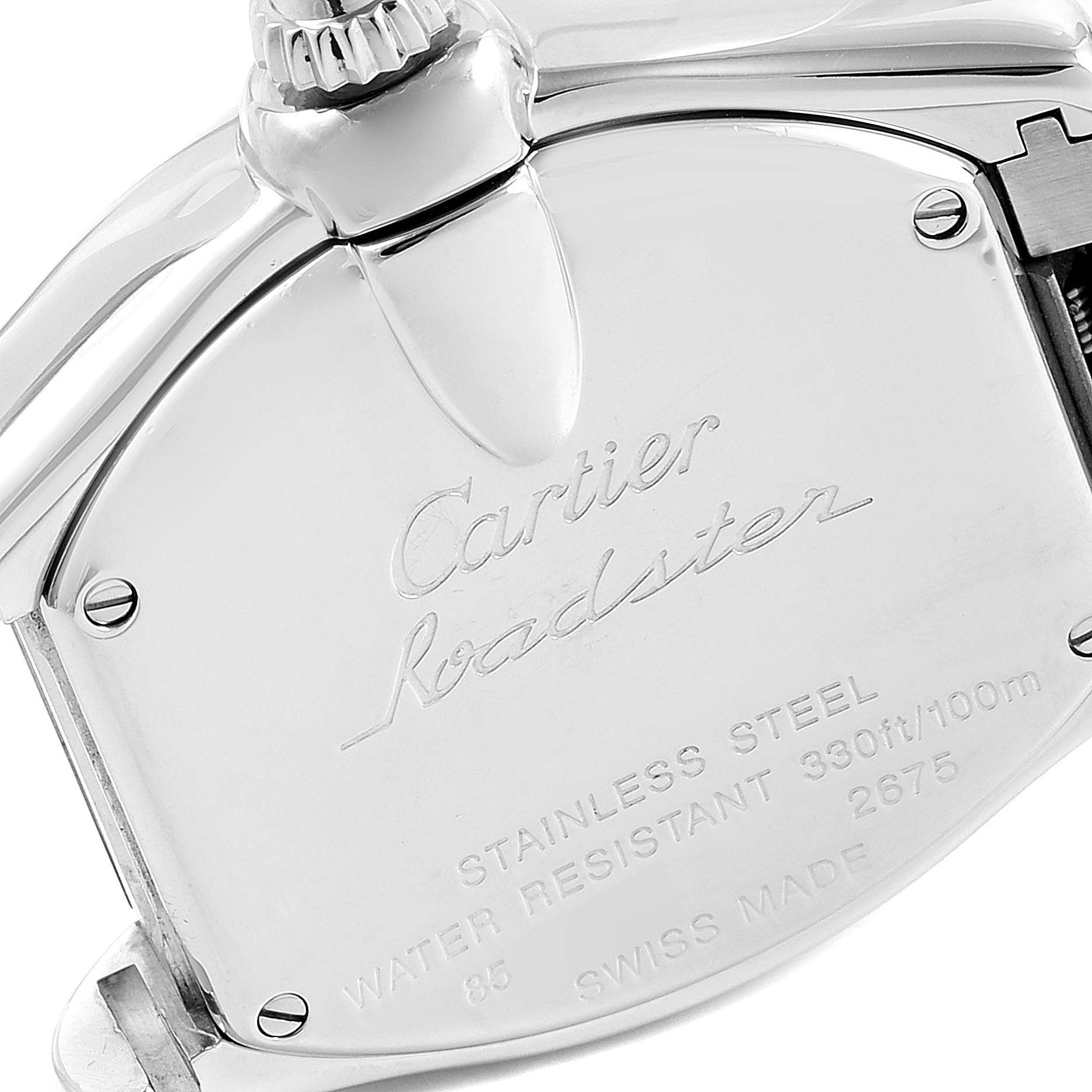 The image shows the back case with engravings and part of the crown of a Roadster model watch by Cartier.