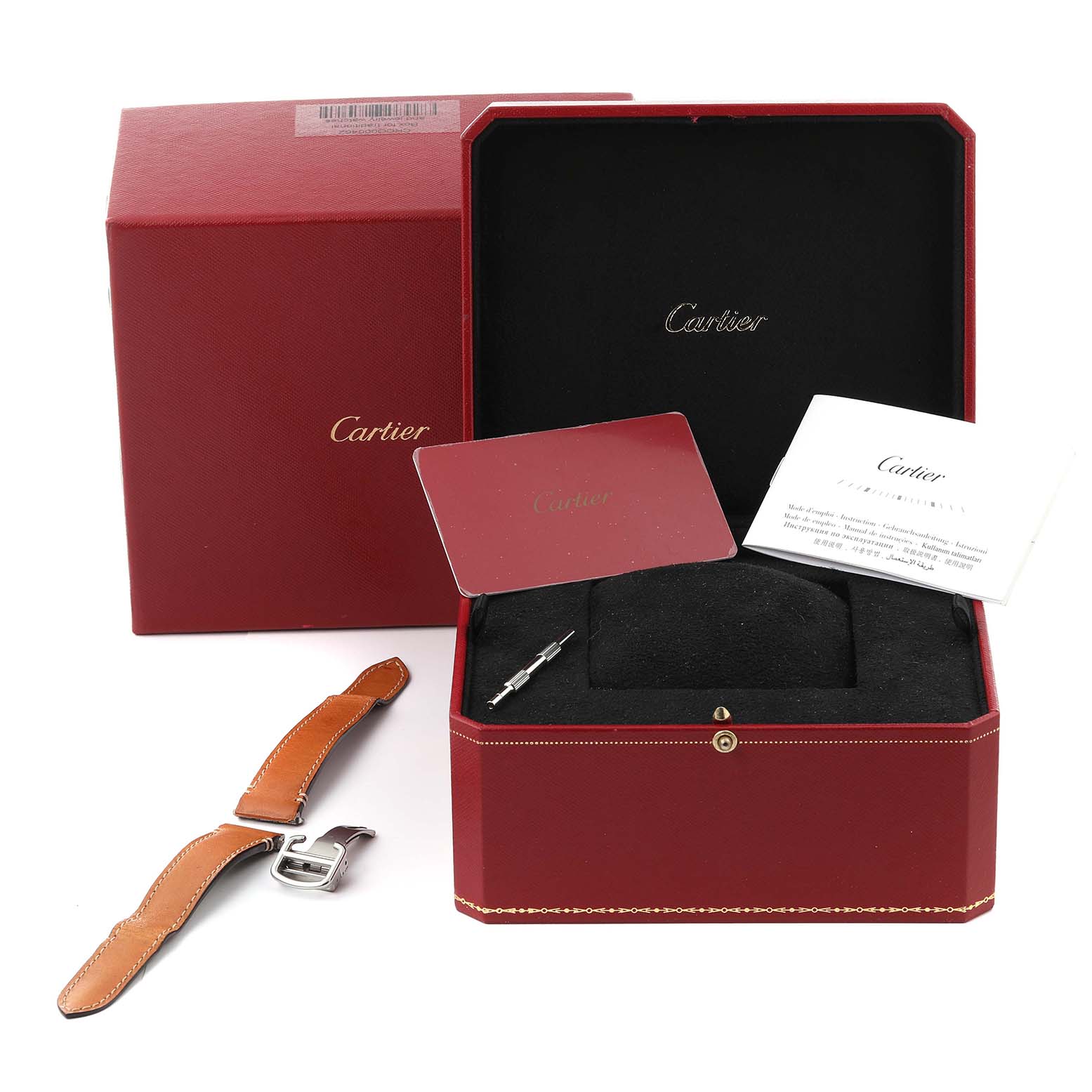 The image shows a Cartier Santos WSSA0010 Men's Stainless Steel Silver Dial WSSA0010 Men's Stainless Steel Silver Dial watch box, a leather strap, a booklet, and a tool, viewed from above.