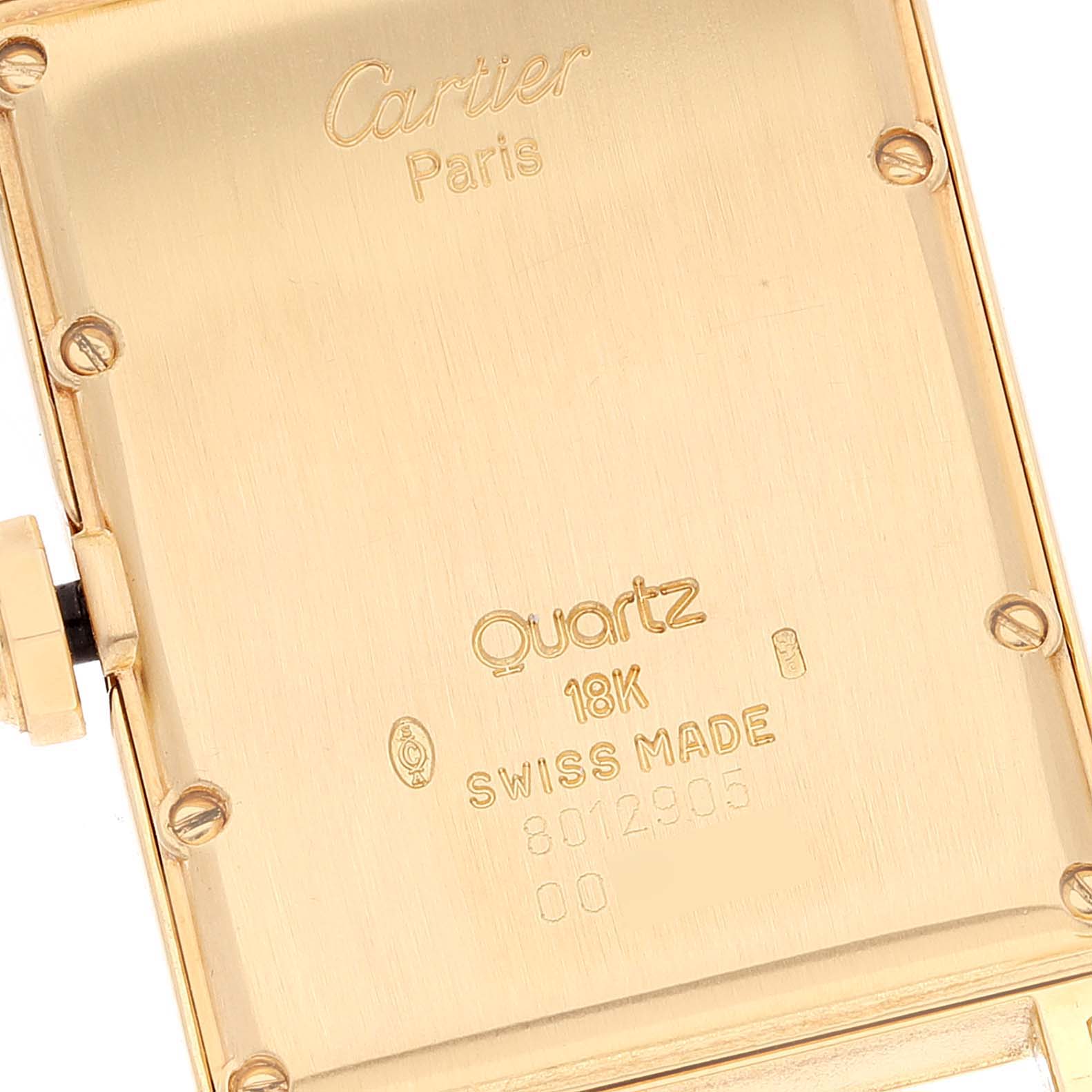This is the back case of the Cartier Tank Américaine watch, displaying "Cartier" branding and specifications including "Quartz" and "18K".
