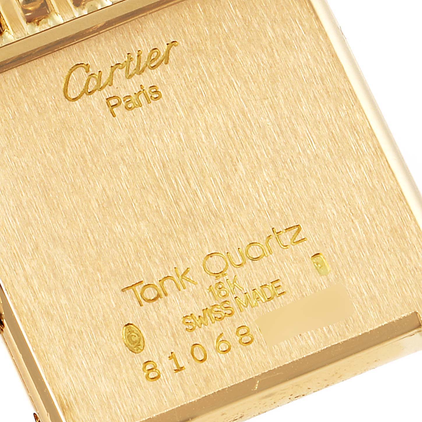 This is a close-up of the back of the Tank Classic model by Cartier, showing inscriptions and serial numbers.