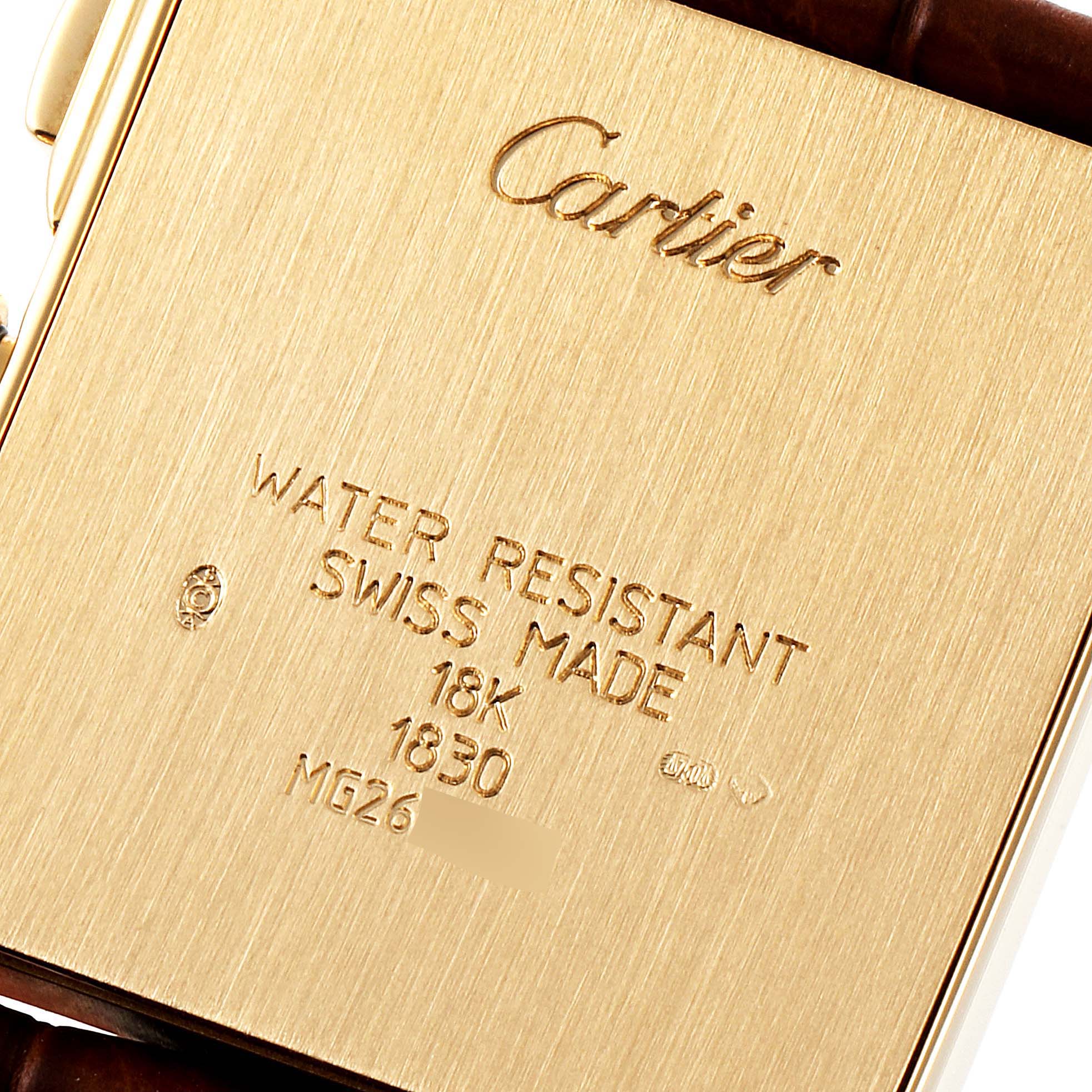 The image shows the back case of a Cartier Tank Francaise W5000556 Men's Yellow Gold Silver Dial W5000556 Men's Yellow Gold Silver Dial watch, engraved with brand details and specifications.