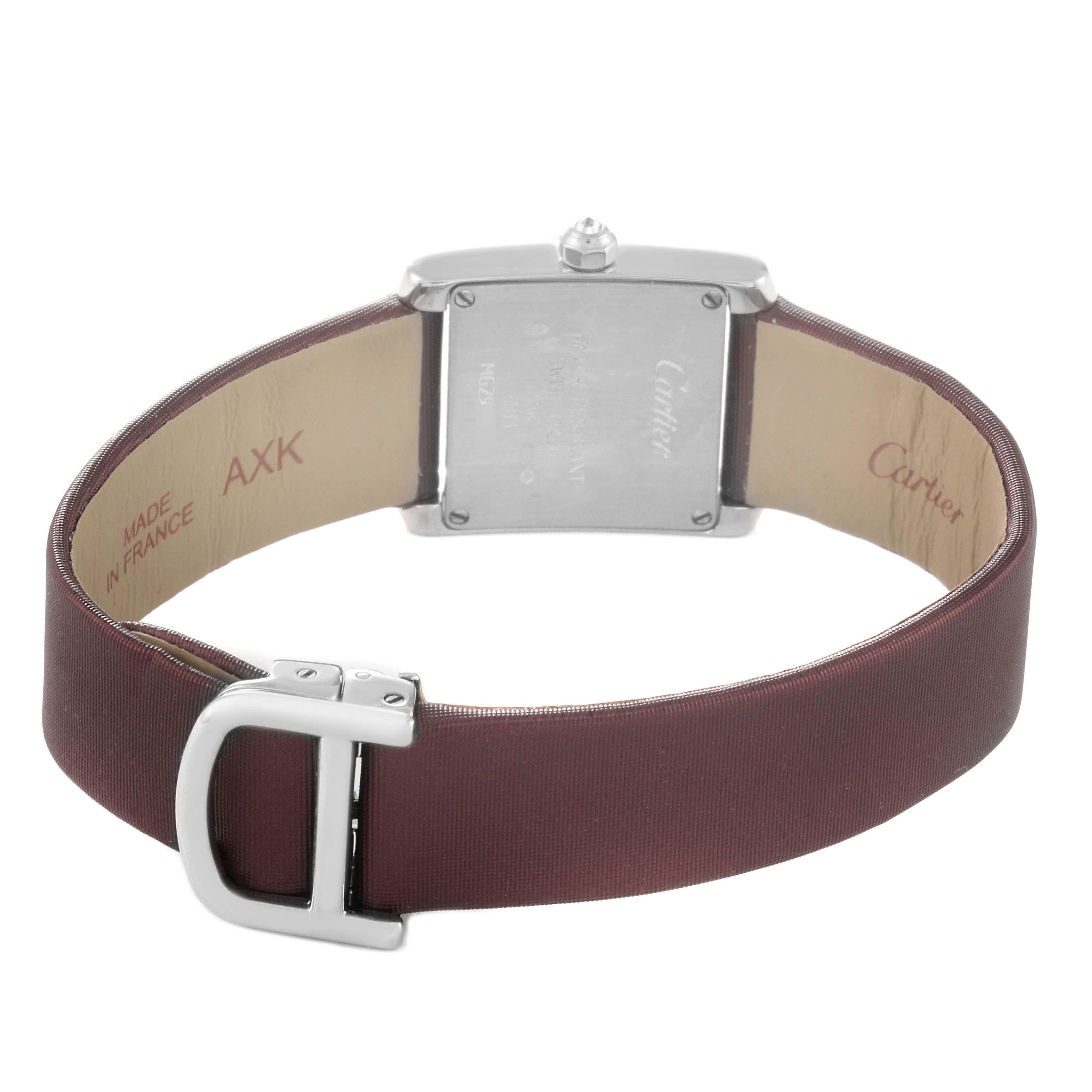 The image shows the back view of a Cartier Tank Française watch, highlighting the case back and brown strap with buckle.