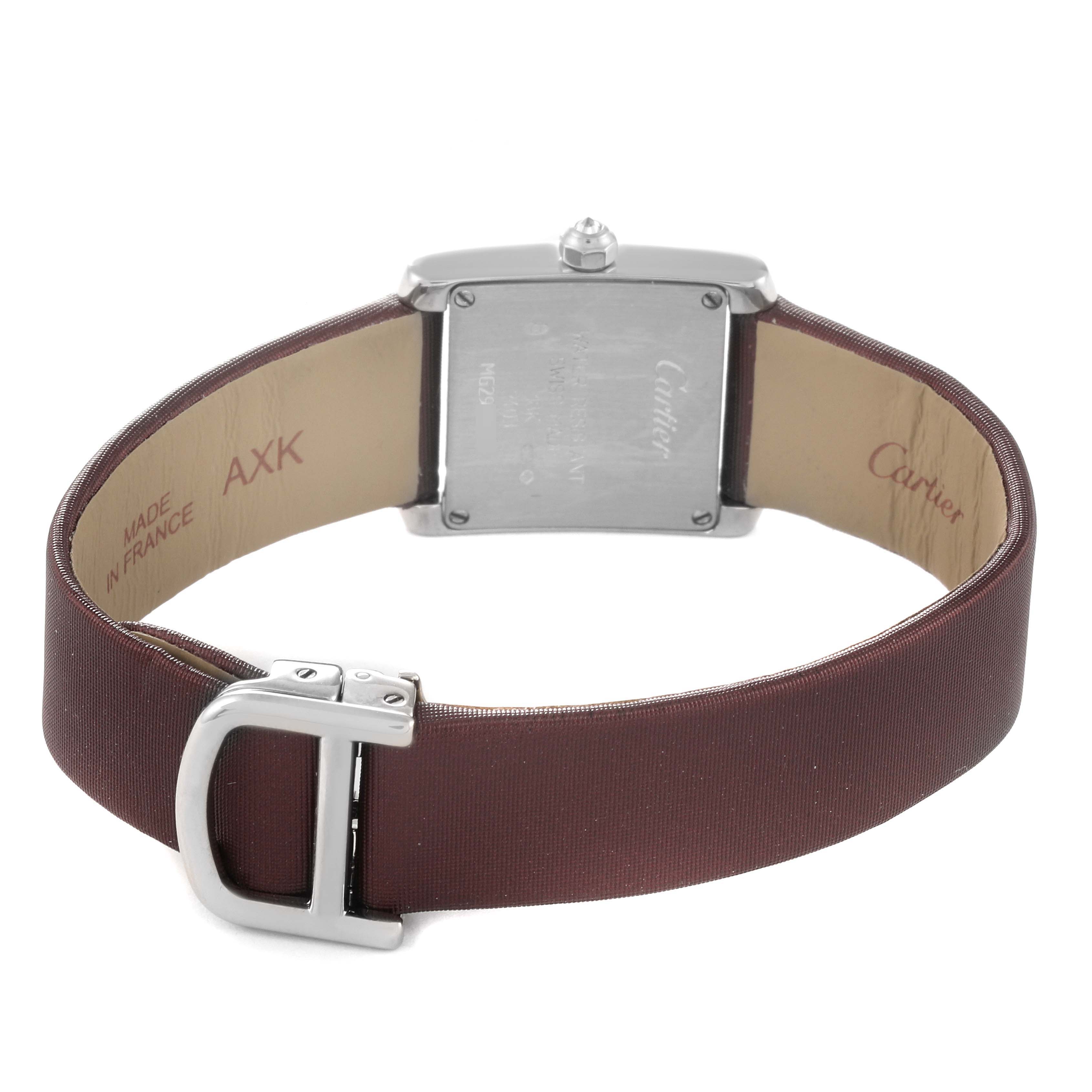 The image shows the back of a Cartier Tank Française watch with a brown leather strap and stainless steel clasp.