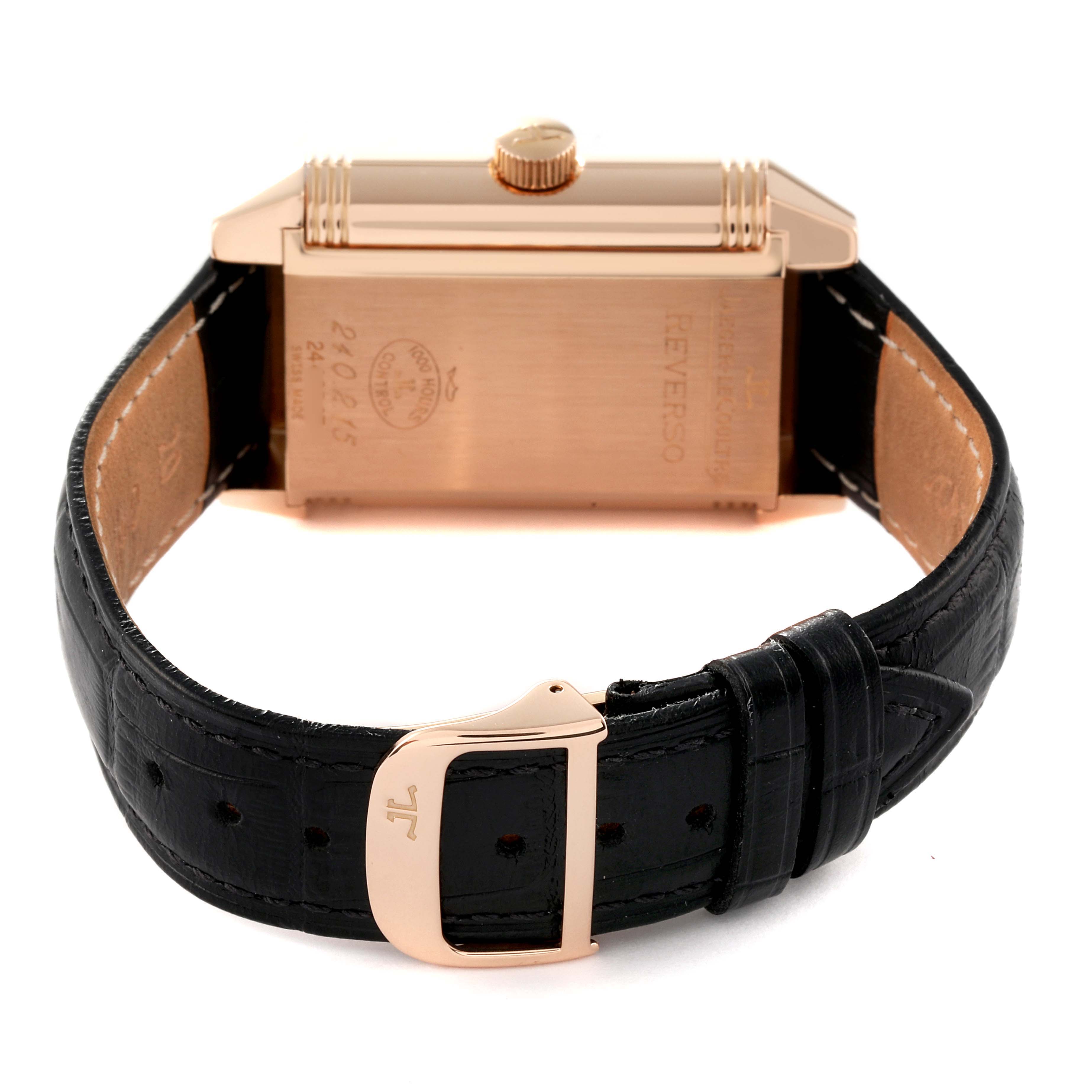 The image shows the back view of a Jaeger-LeCoultre Reverso watch, highlighting the case, crown, and black leather strap with buckle.
