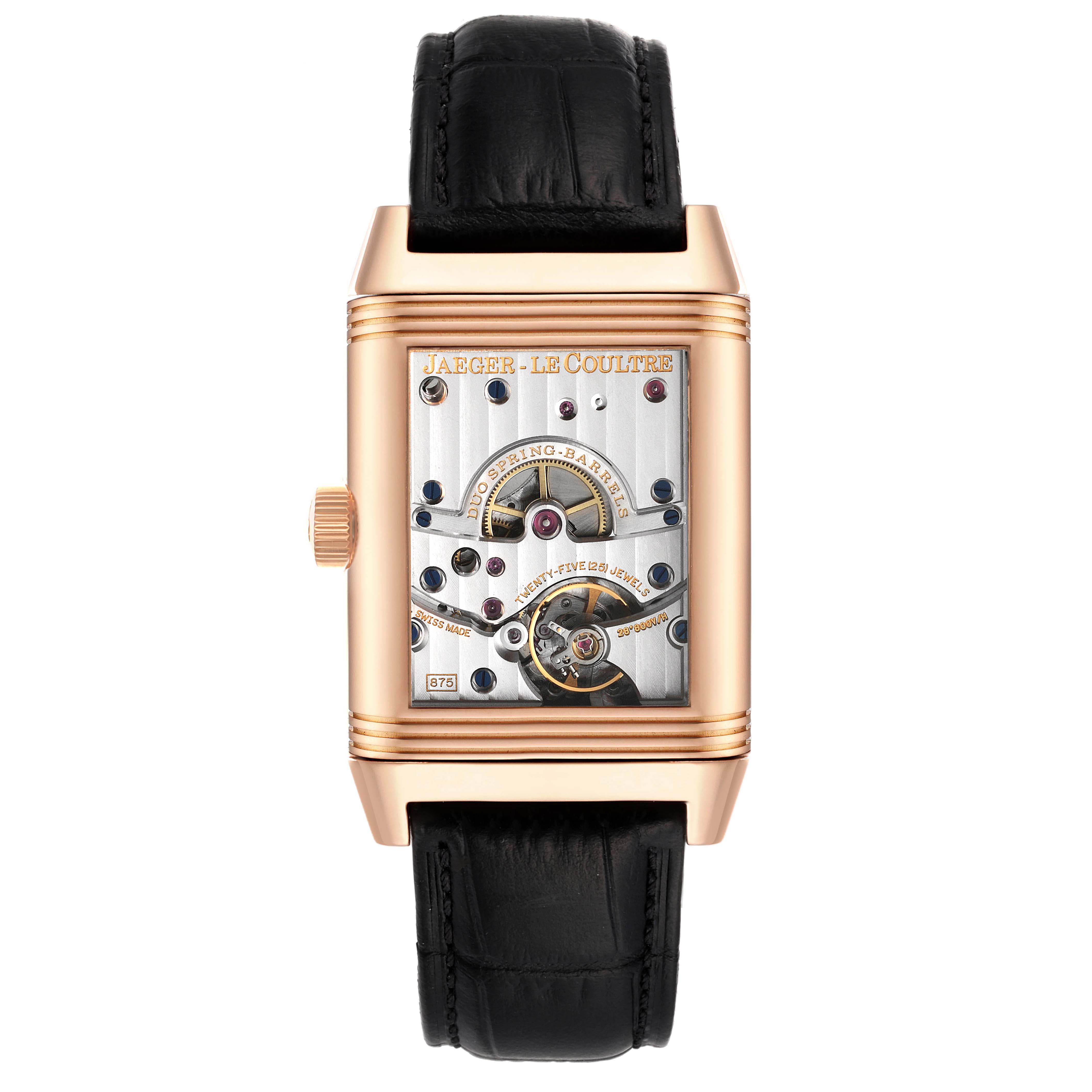 The image shows a Jaeger-LeCoultre Reverso model watch from the front, displaying its internal mechanism and black leather strap.