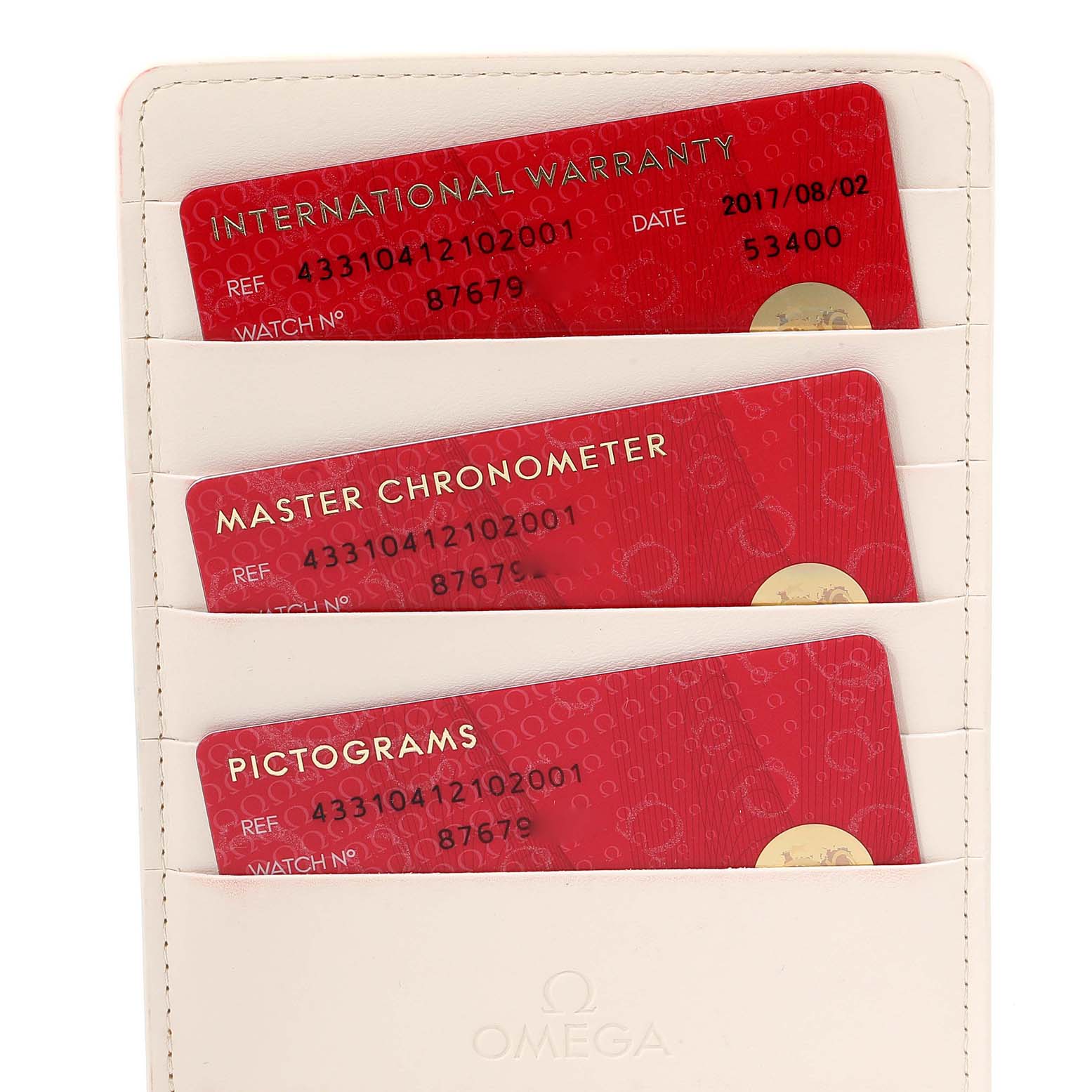 This image shows the international warranty, master chronometer, and pictograms cards for the Omega De Ville 433.10.41.21.02.001 Men's Stainless Steel Silver Dial 433.10.41.21.02.001 Men's Stainless Steel Silver Dial watch.