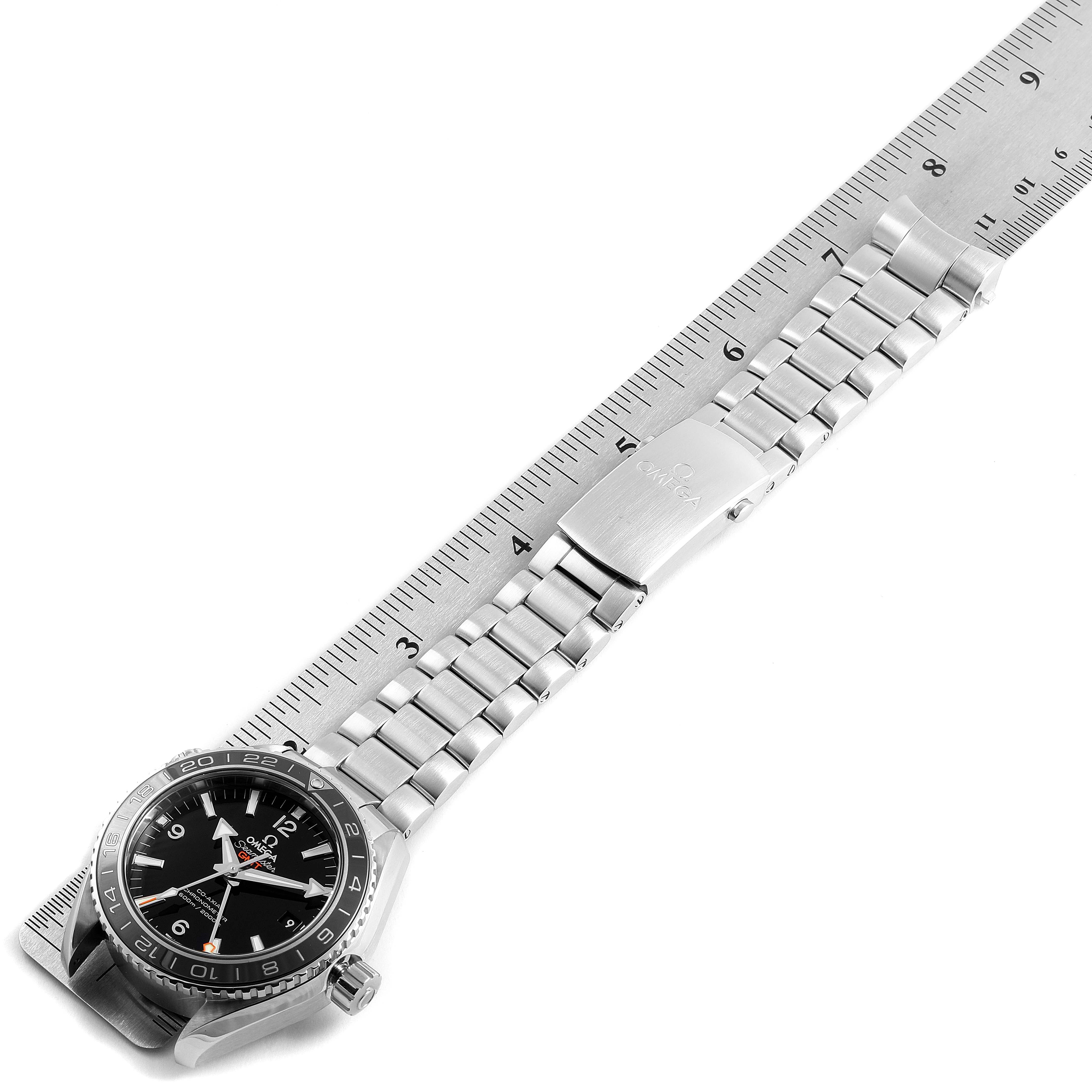 The image shows an Omega Planet Ocean 232.30.44.22.01.001 Men
s Stainless Steel Black Dial 232.30.44.22.01.001 Men
s Stainless Steel Black Dial watch from the top angle, laid flat alongside a ruler to measure its length.