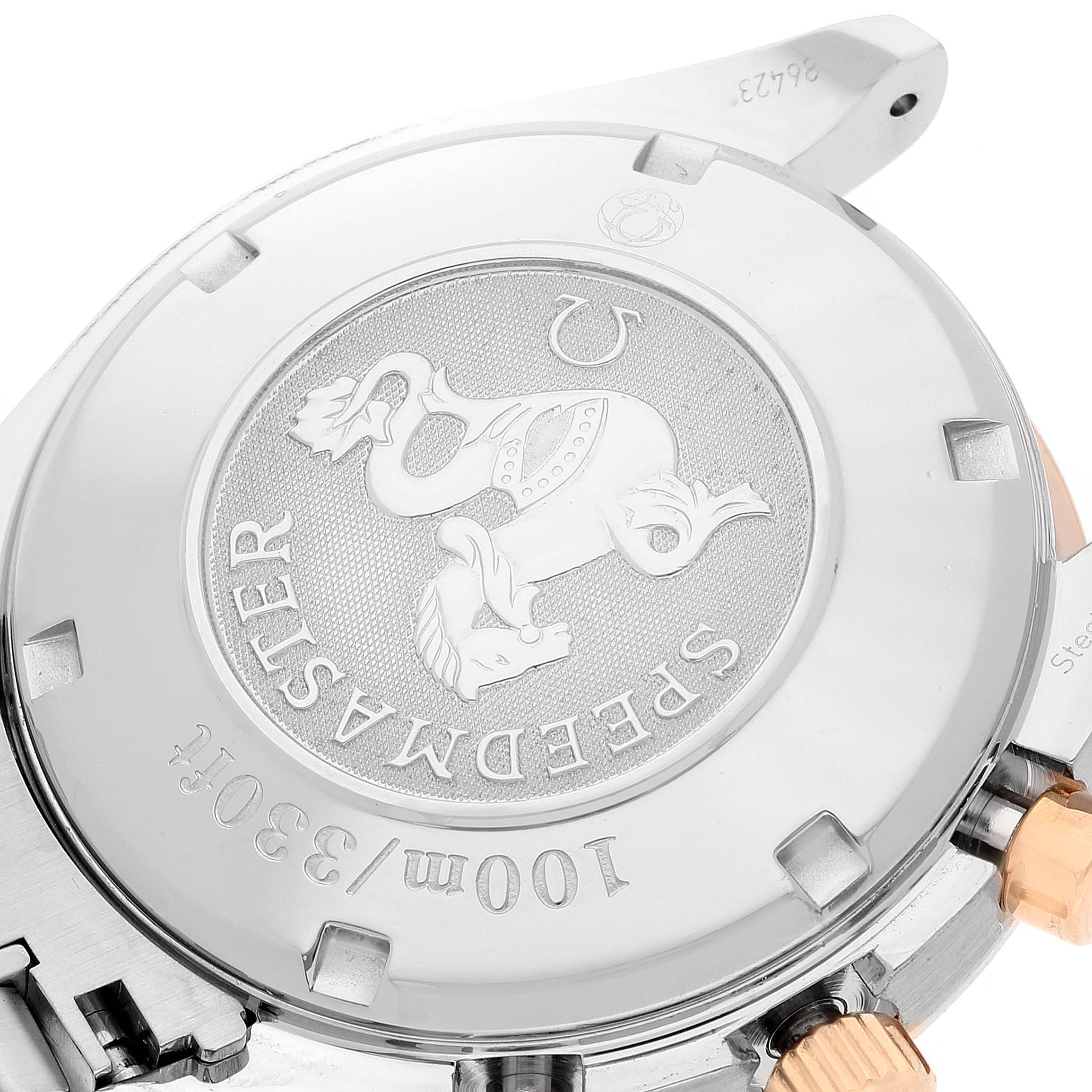 This image shows the back case of an Omega Speedmaster 323.21.40.40.01.001 Men's Steel and Gold (two tone) Black Dial 323.21.40.40.01.001 Men's Steel and Gold (two tone) Black Dial watch, highlighting its engravings and detailing.