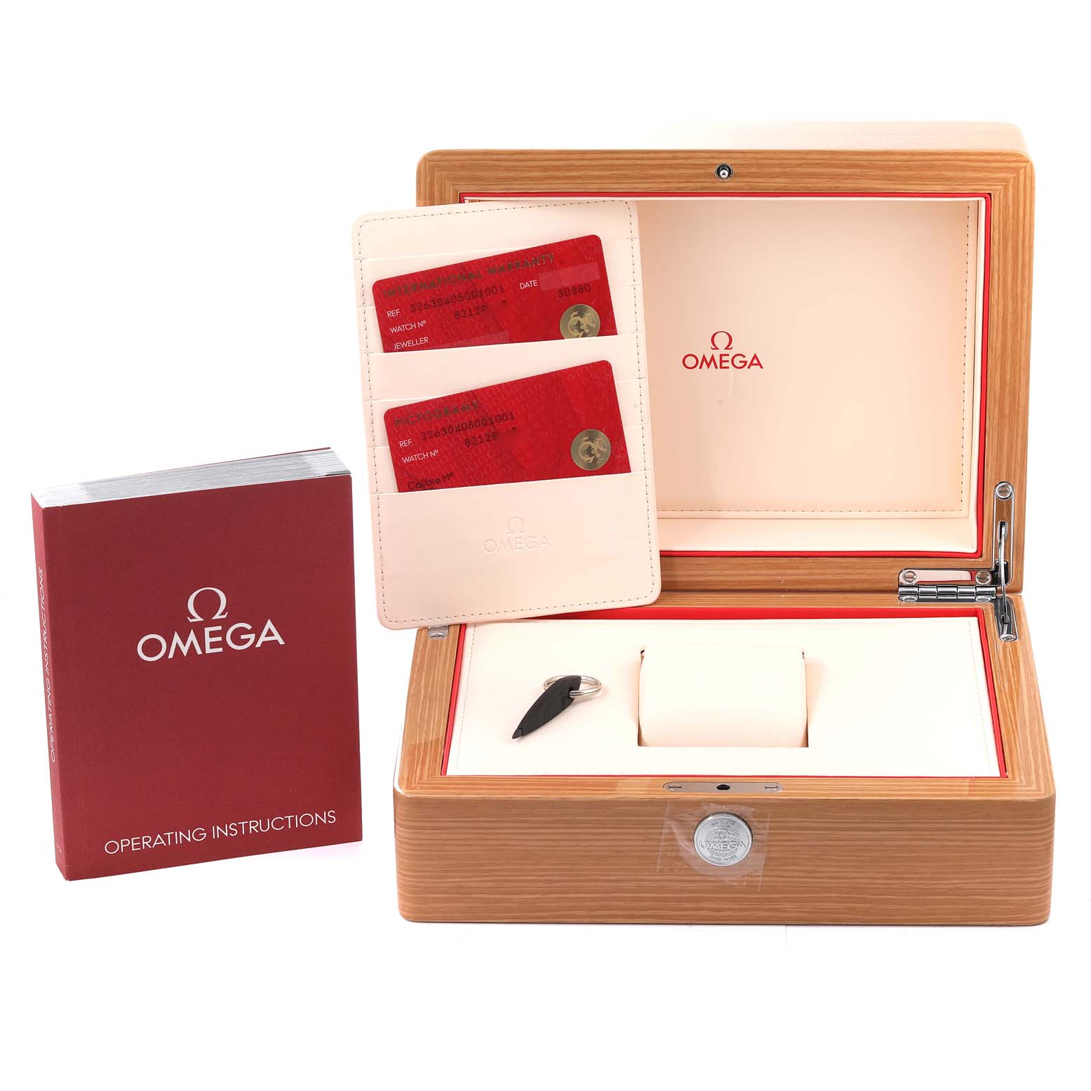 The image shows an Omega Speedmaster 326.30.40.50.01.001 Men's Stainless Steel Black Dial 326.30.40.50.01.001 Men's Stainless Steel Black Dial watch box, warranty cards, operating instructions, and a tool, all from a front angle.