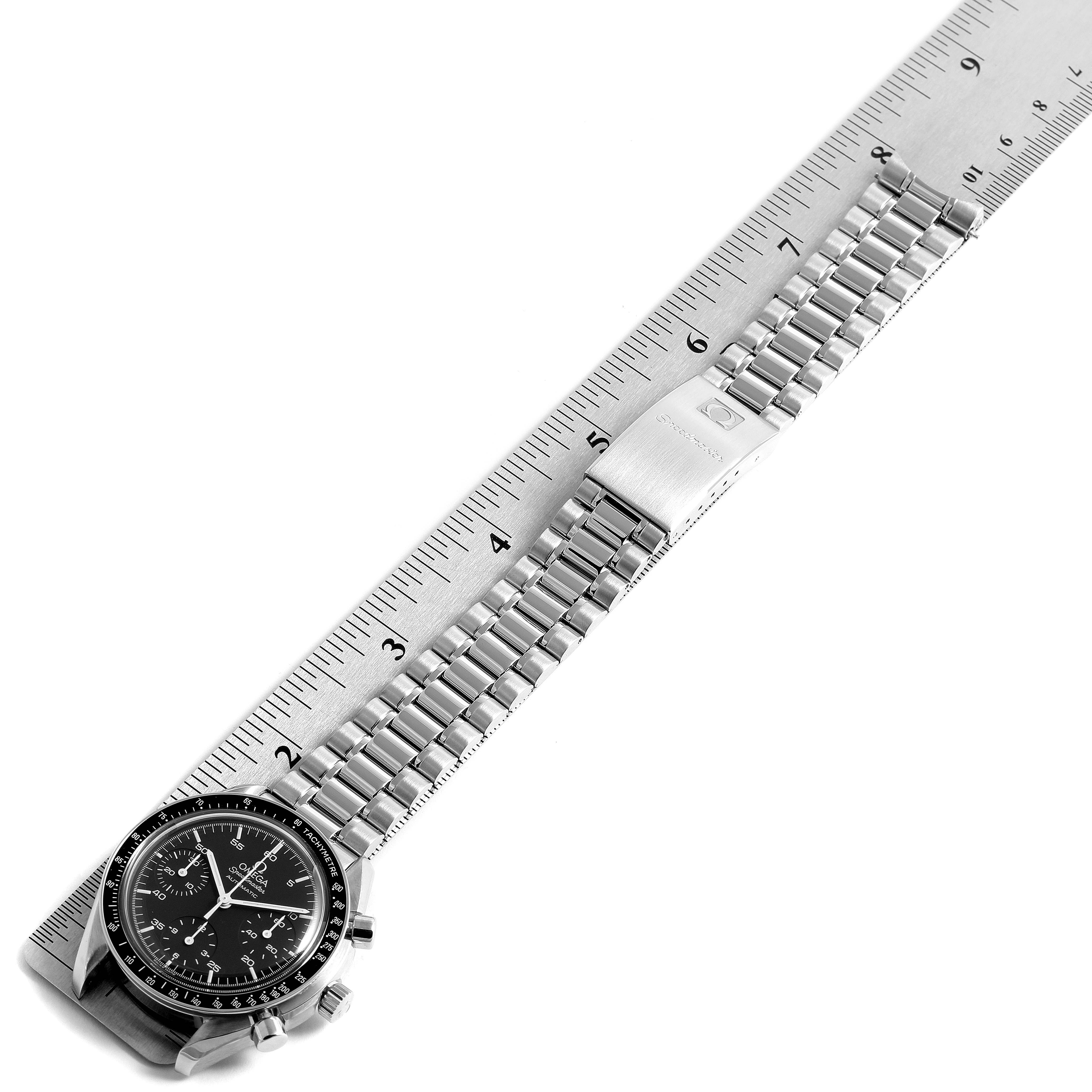 The image shows an Omega Speedmaster 3510.50.00 Men
s Stainless Steel Black Dial 3510.50.00 Men
s Stainless Steel Black Dial watch laid flat alongside a ruler, highlighting its case and metal bracelet.