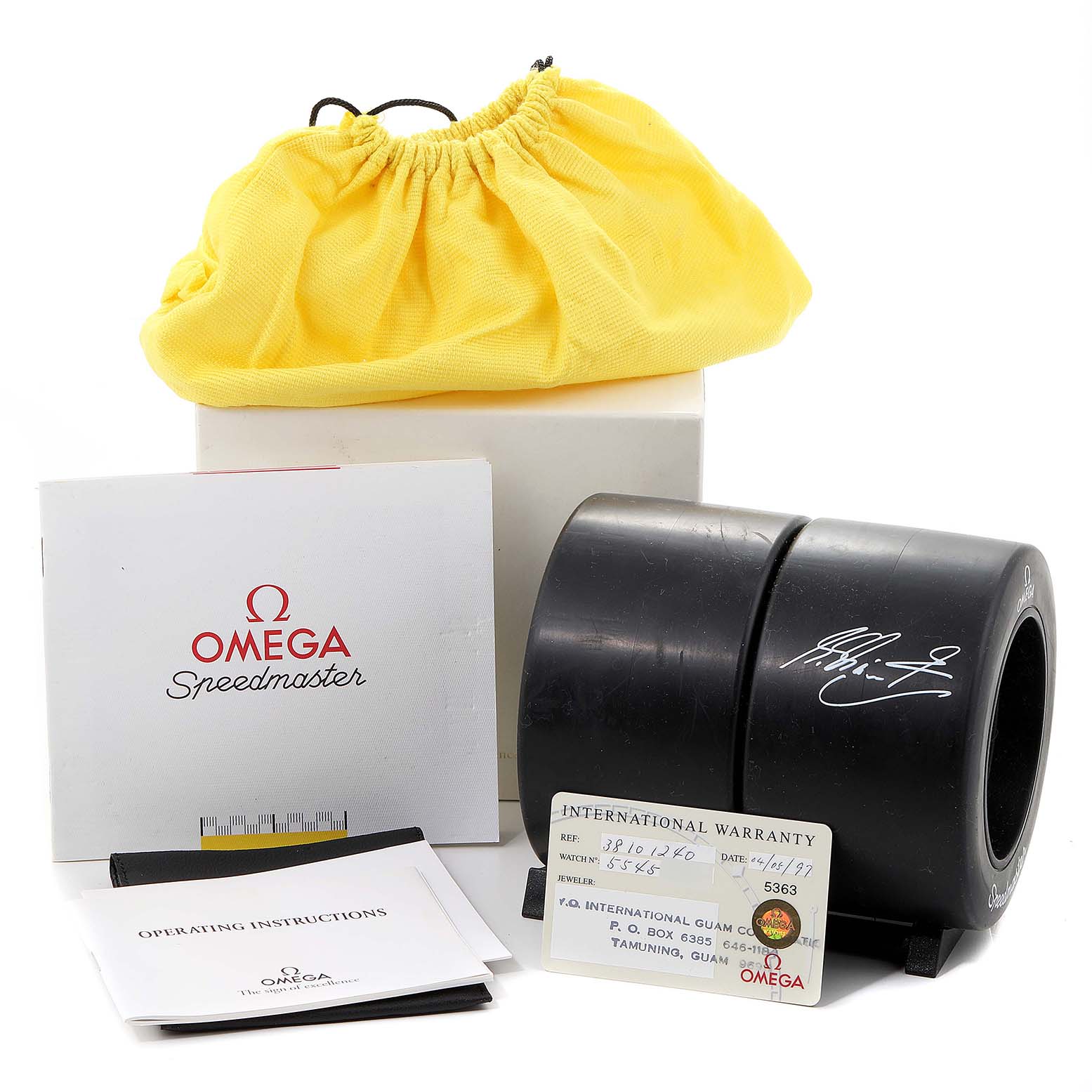 The image shows Omega Speedmaster 3810.12.40 Men's Stainless Steel Yellow Dial 3810.12.40 Men's Stainless Steel Yellow Dial accessories including a box, a yellow pouch, instruction manuals, a warranty card, and a black case.