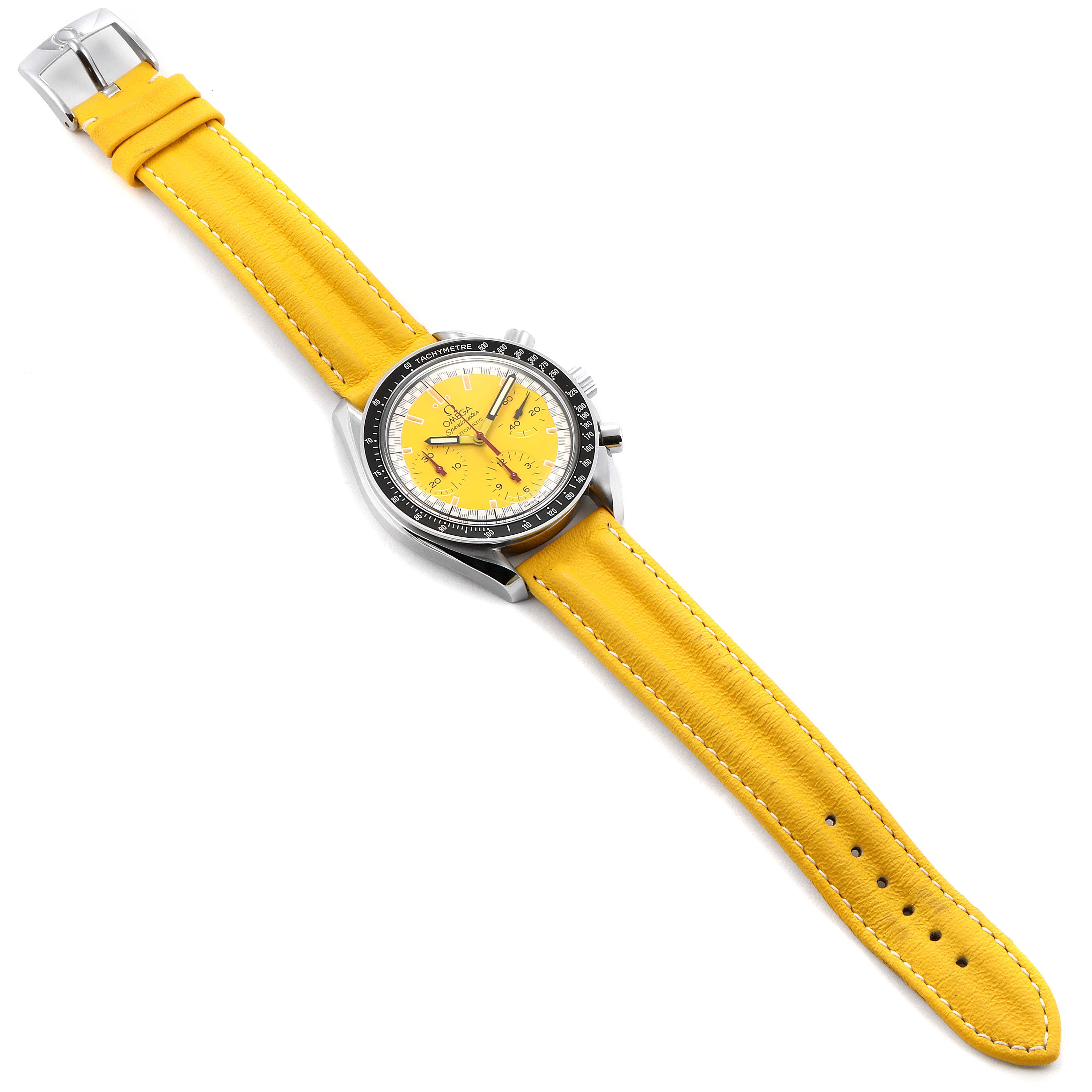 The image shows an Omega Speedmaster 3810.12.40 Men's Stainless Steel Yellow Dial 3810.12.40 Men's Stainless Steel Yellow Dial watch from a top-down angle, featuring a yellow leather strap and yellow dial.