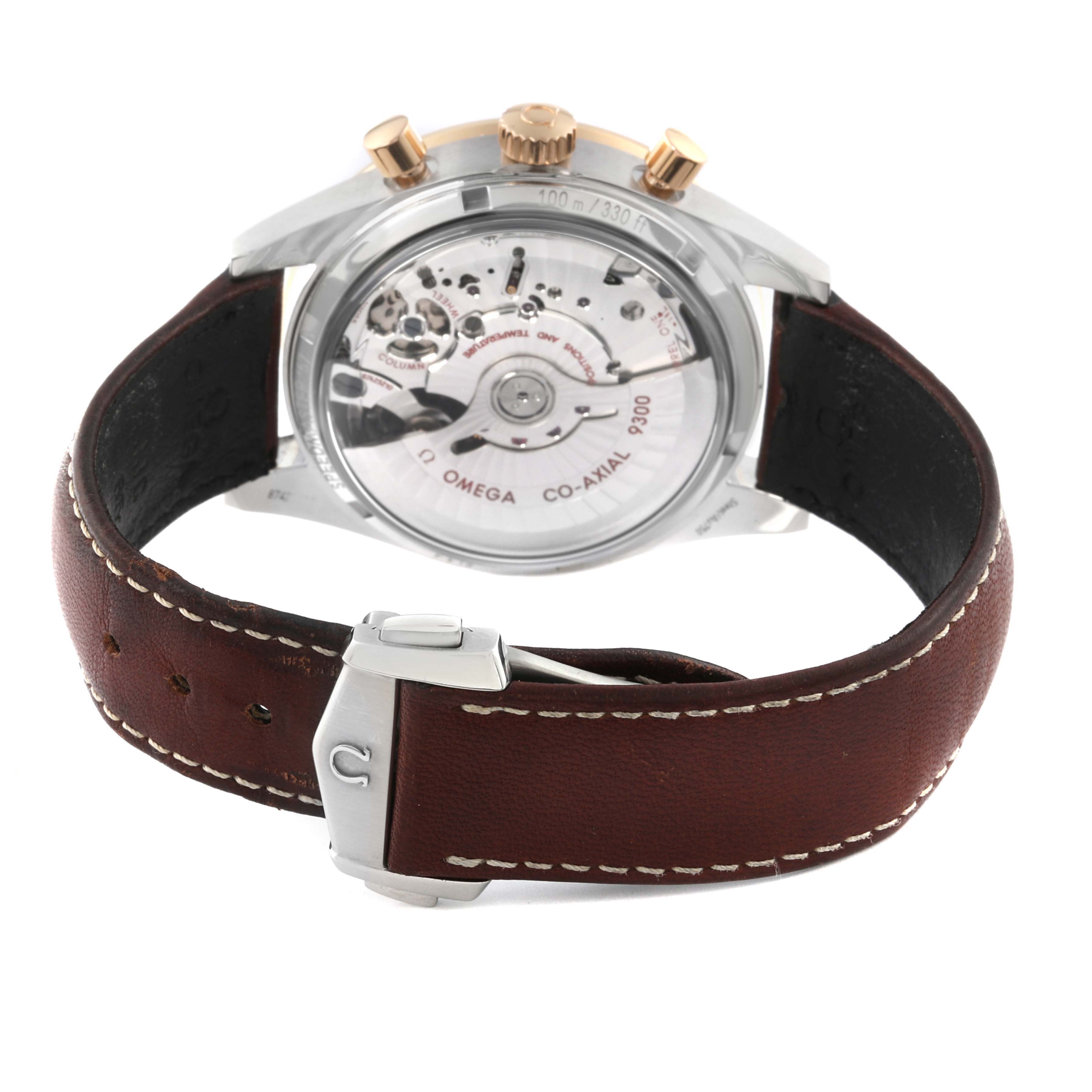 The Omega Speedmaster 331.22.42.51.01.001 Men's Steel and Gold (two tone) Black Dial 331.22.42.51.01.001 Men's Steel and Gold (two tone) Black Dial watch is shown from the back, revealing the movement and featuring a brown leather strap with a clasp.