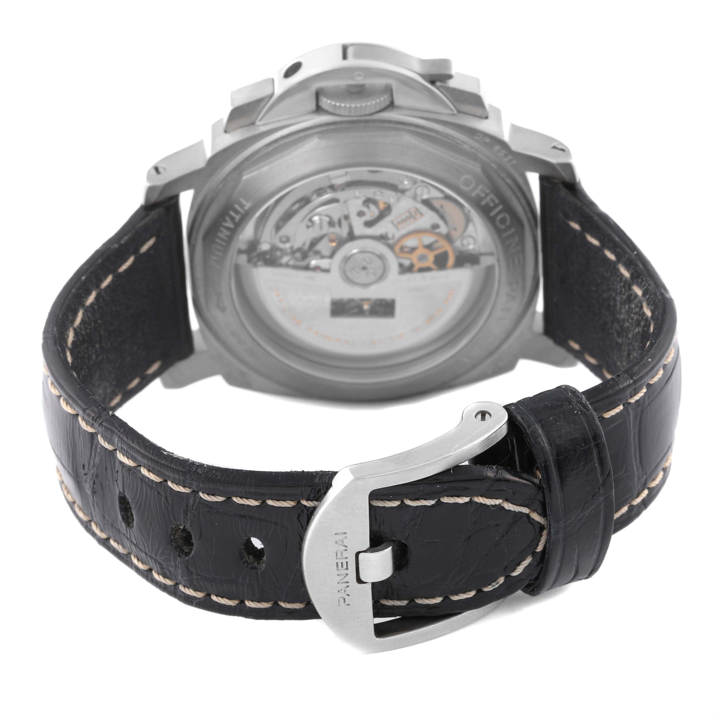 The image shows the back view of a Panerai Luminor PAM00074 Men's Titanium Black Dial PAM00074 Men's Titanium Black Dial watch, highlighting the case back, movement, and leather strap with buckle.