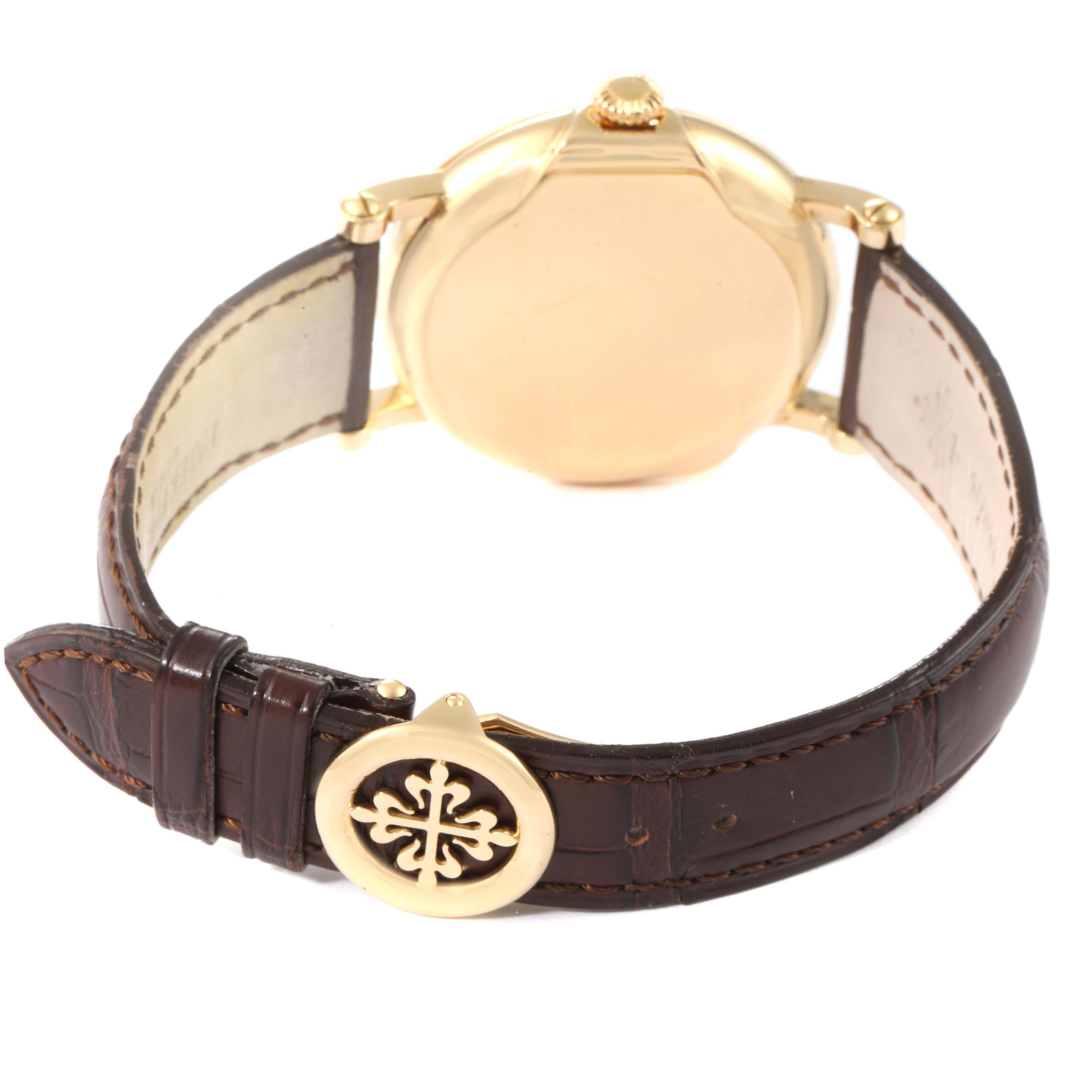 The image shows a rear view of the Patek Philippe Calatrava 5153J Men's Yellow Gold Silver Dial 5153J Men's Yellow Gold Silver Dial watch, highlighting the back case and leather strap with a branded buckle.