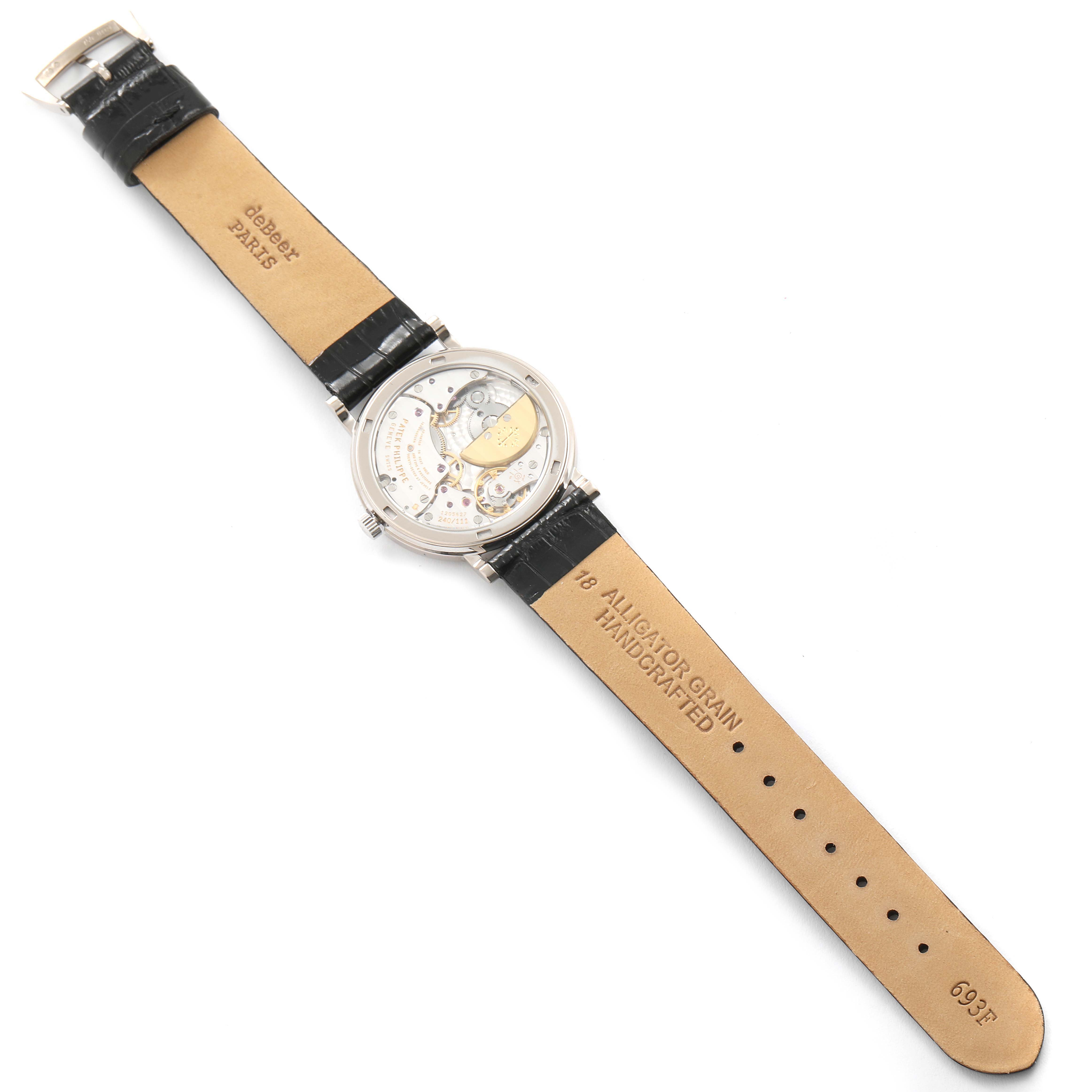 This image shows the back view of a Patek Philippe Calatrava 5120G Men's White Gold White Dial 5120G Men's White Gold White Dial watch, featuring the inner mechanics and leather straps.