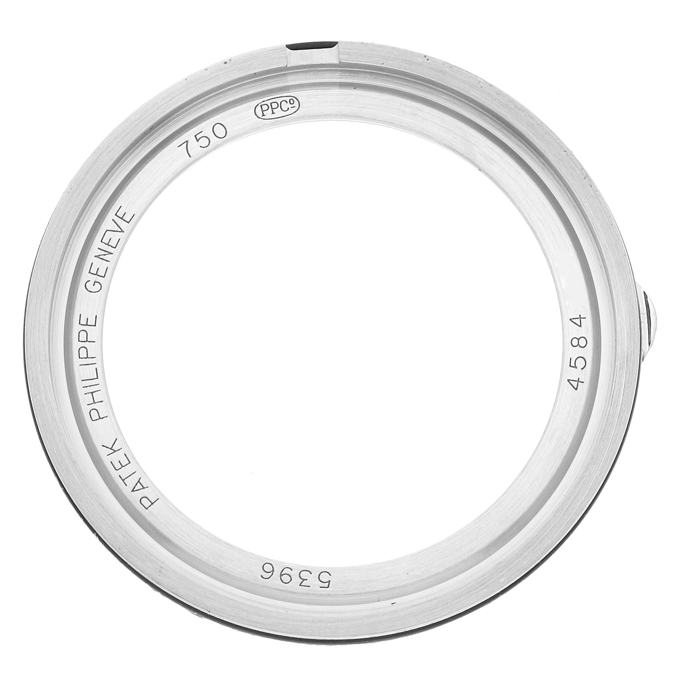 The image shows the bezel of a Patek Philippe Complications 5396G - 011 Men's White Gold Silver Dial 5396G - 011 Men's White Gold Silver Dial watch from a top-down angle.