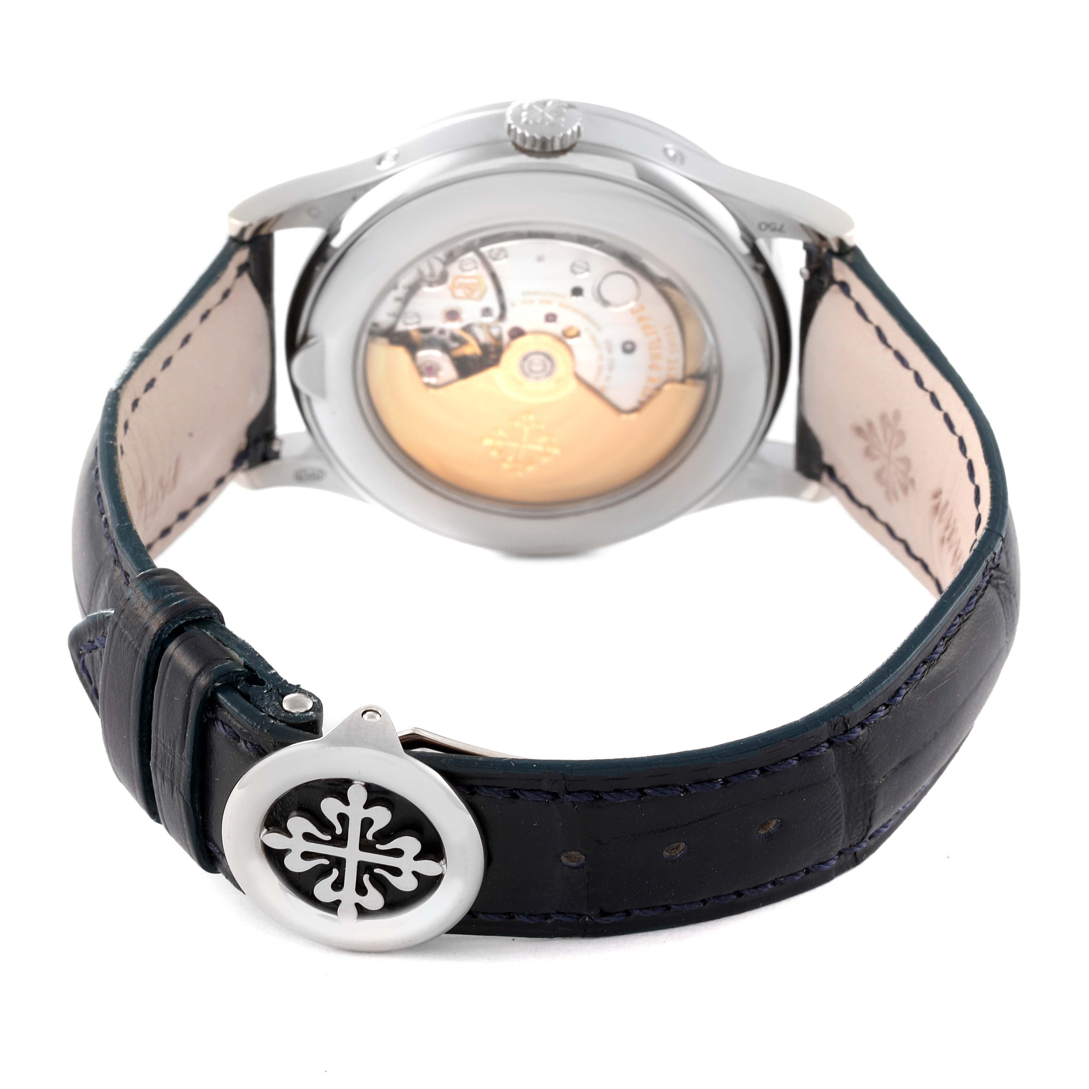 The image shows the back view of a Patek Philippe Complications 5396G - 011 Men's White Gold Silver Dial 5396G - 011 Men's White Gold Silver Dial watch, highlighting the movement and leather strap.