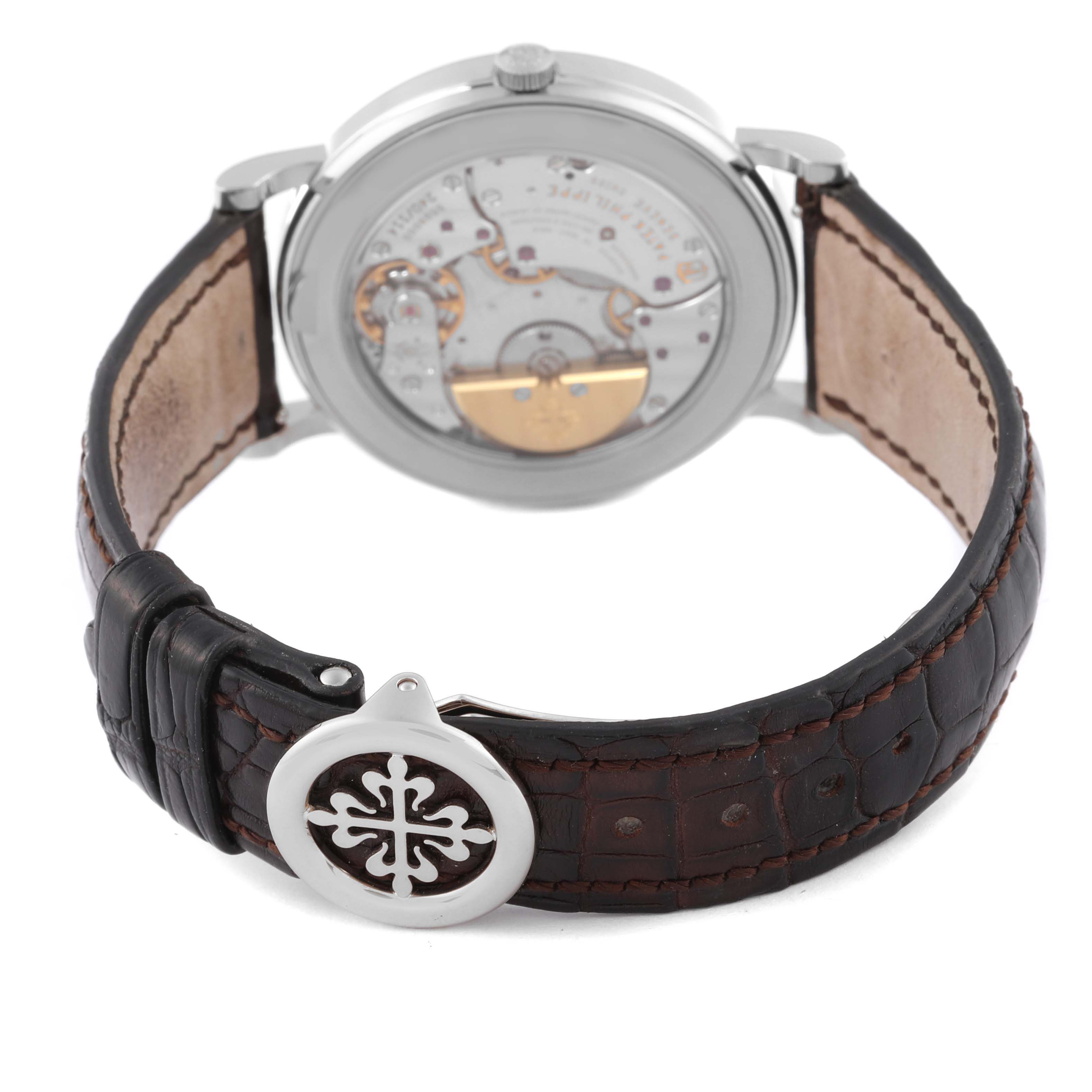 The image shows the back view of a Patek Philippe Complications 5139G-001 Men's White Gold Grey Dial 5139G-001 Men's White Gold Grey Dial model, highlighting its exposed movement and leather strap.