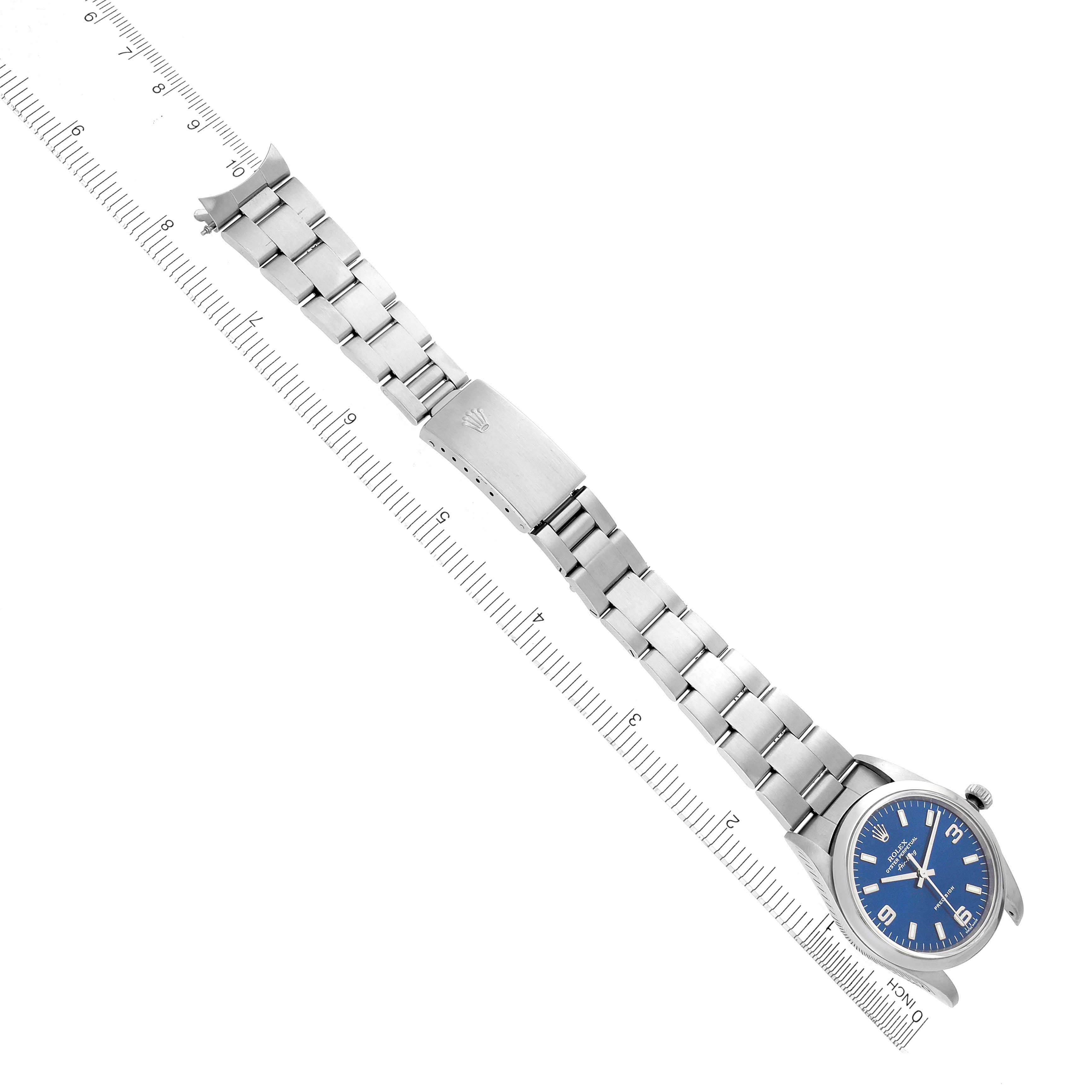 The Rolex Air-King 14000 Men's Stainless Steel Blue Dial 14000 Men's Stainless Steel Blue Dial is shown at a slight diagonal, displaying the watch face and full metal bracelet alongside a ruler.