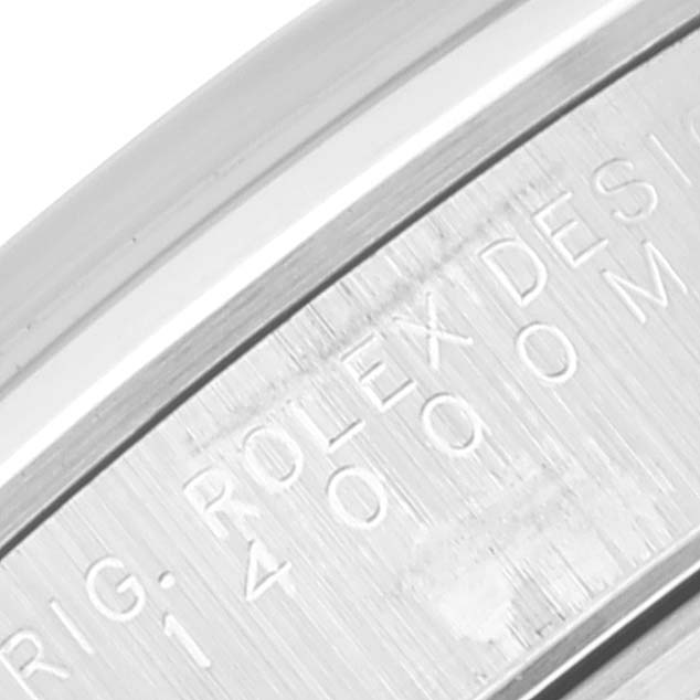 Close-up view of the engraving on the Rolex Air-King 14000 Men's Stainless Steel Silver Dial 14000 Men's Stainless Steel Silver Dial watch's case back, showing part of the branding and design number.