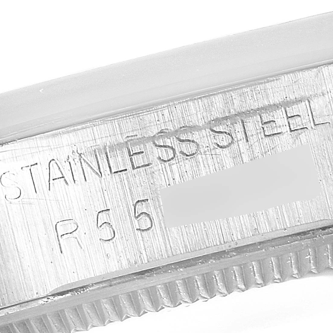 This close-up image shows the side of the stainless steel bezel of a Rolex Vintage Collection 5500 Men's Stainless Steel Silver Dial 5500 Men's Stainless Steel Silver Dial watch.