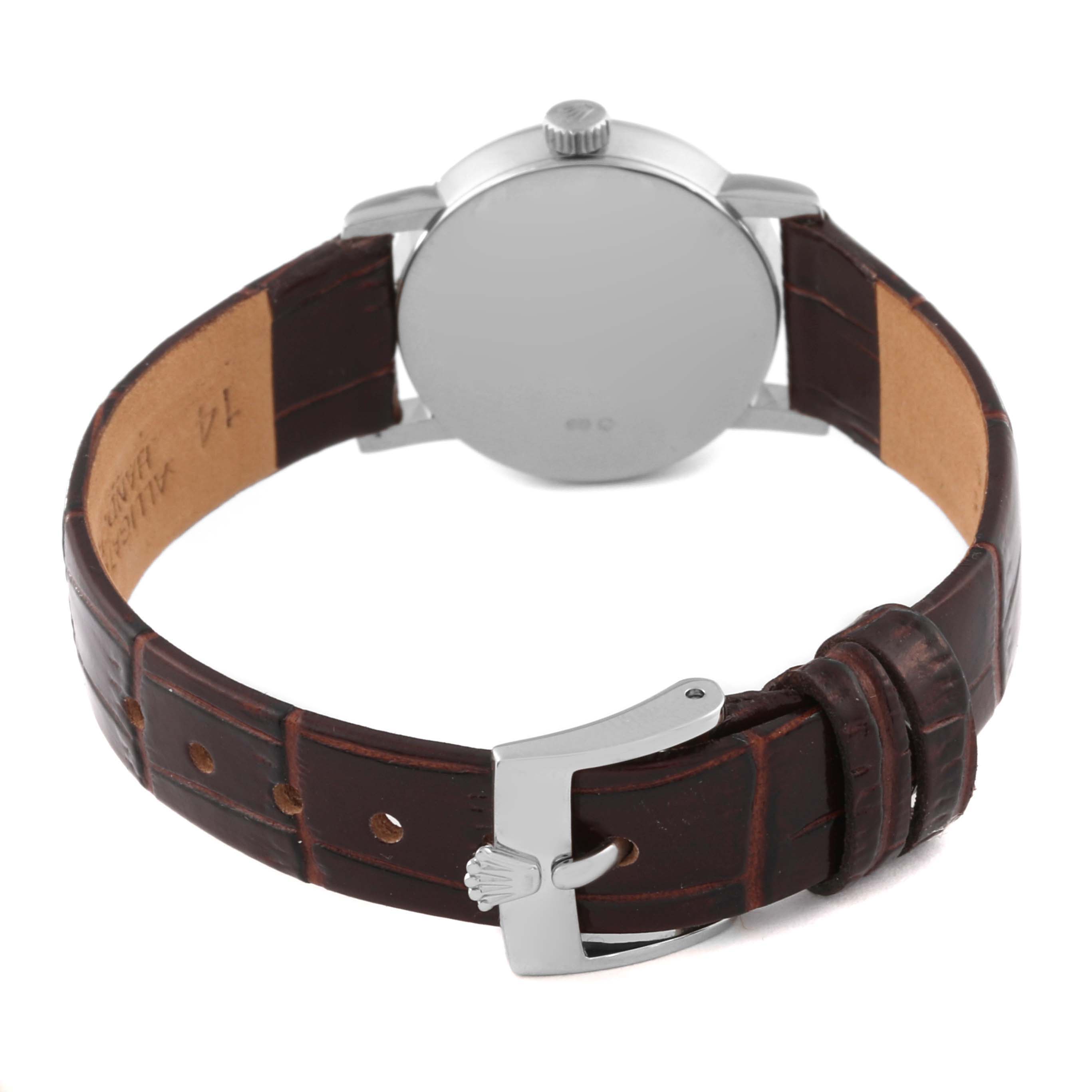 The Rolex Cellini 6110 Women's White Gold Brown Dial 6110 Women's White Gold Brown Dial watch is shown from the back, highlighting the case, crown, and leather strap with a buckle clasp.