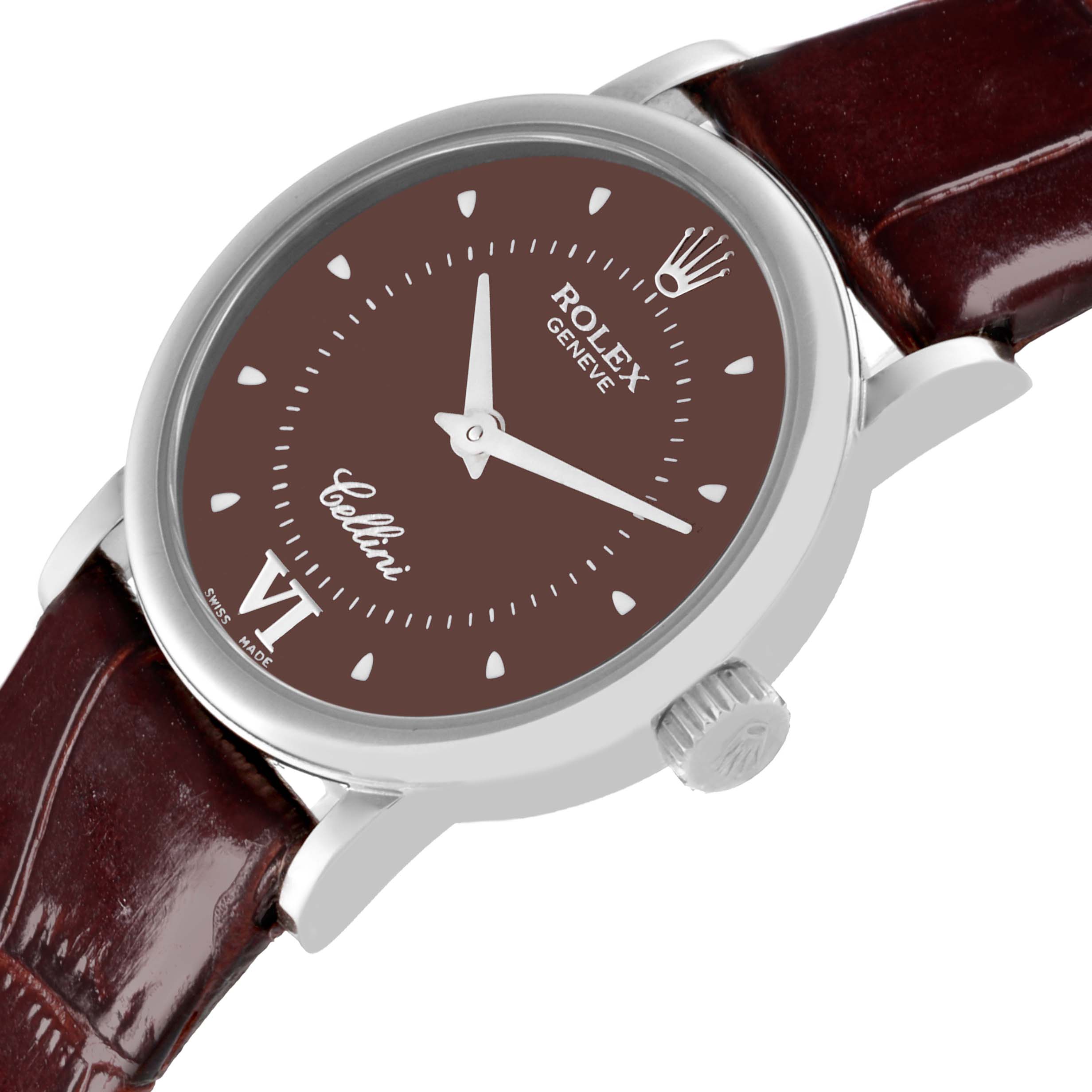 The Rolex Cellini 6110 Women's White Gold Brown Dial 6110 Women's White Gold Brown Dial watch is shown in a tilted side view, displaying the dial, case, crown, and strap.