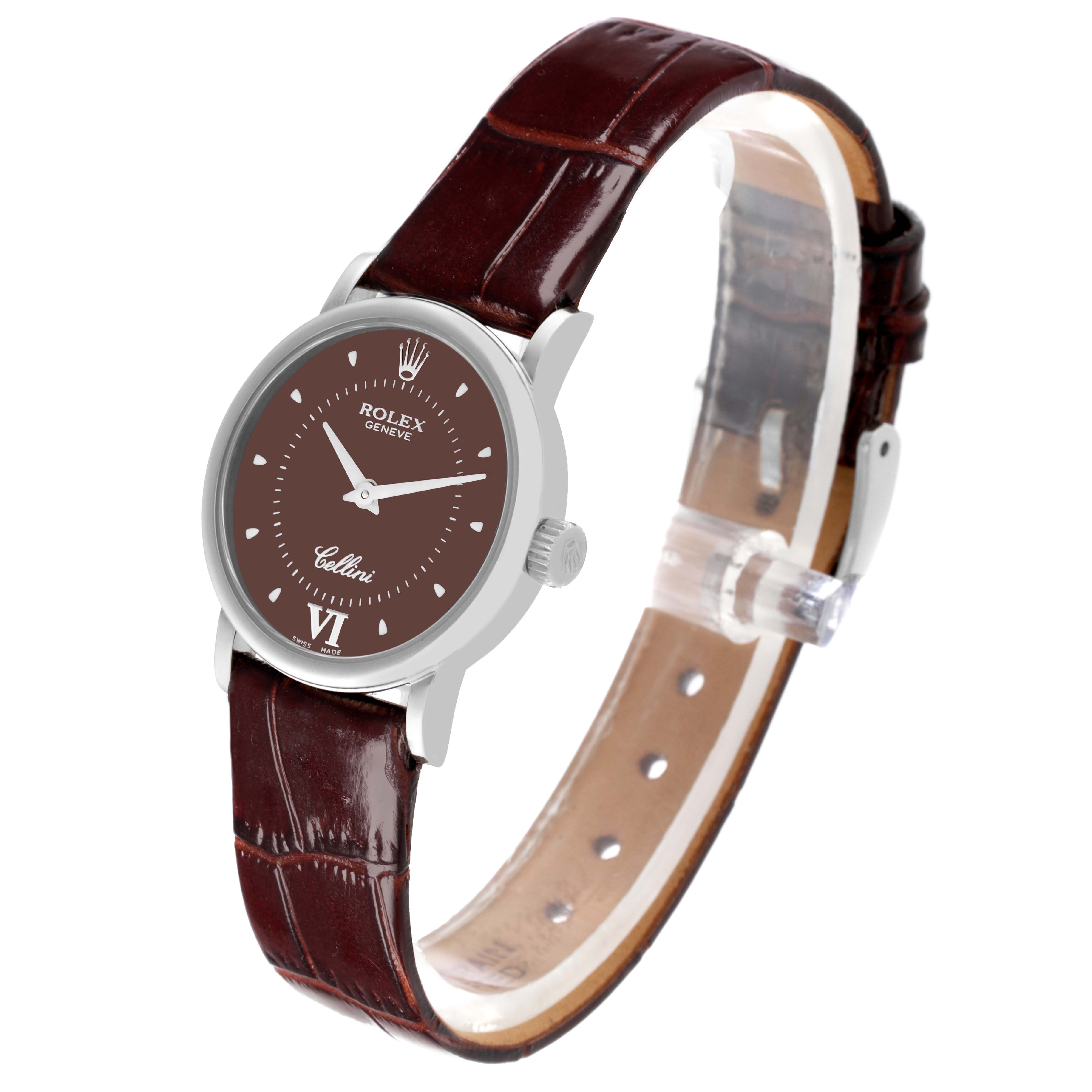 The Rolex Cellini 6110 Women's White Gold Brown Dial 6110 Women's White Gold Brown Dial watch is shown from a side angle, displaying the face, case, crown, and brown leather strap.