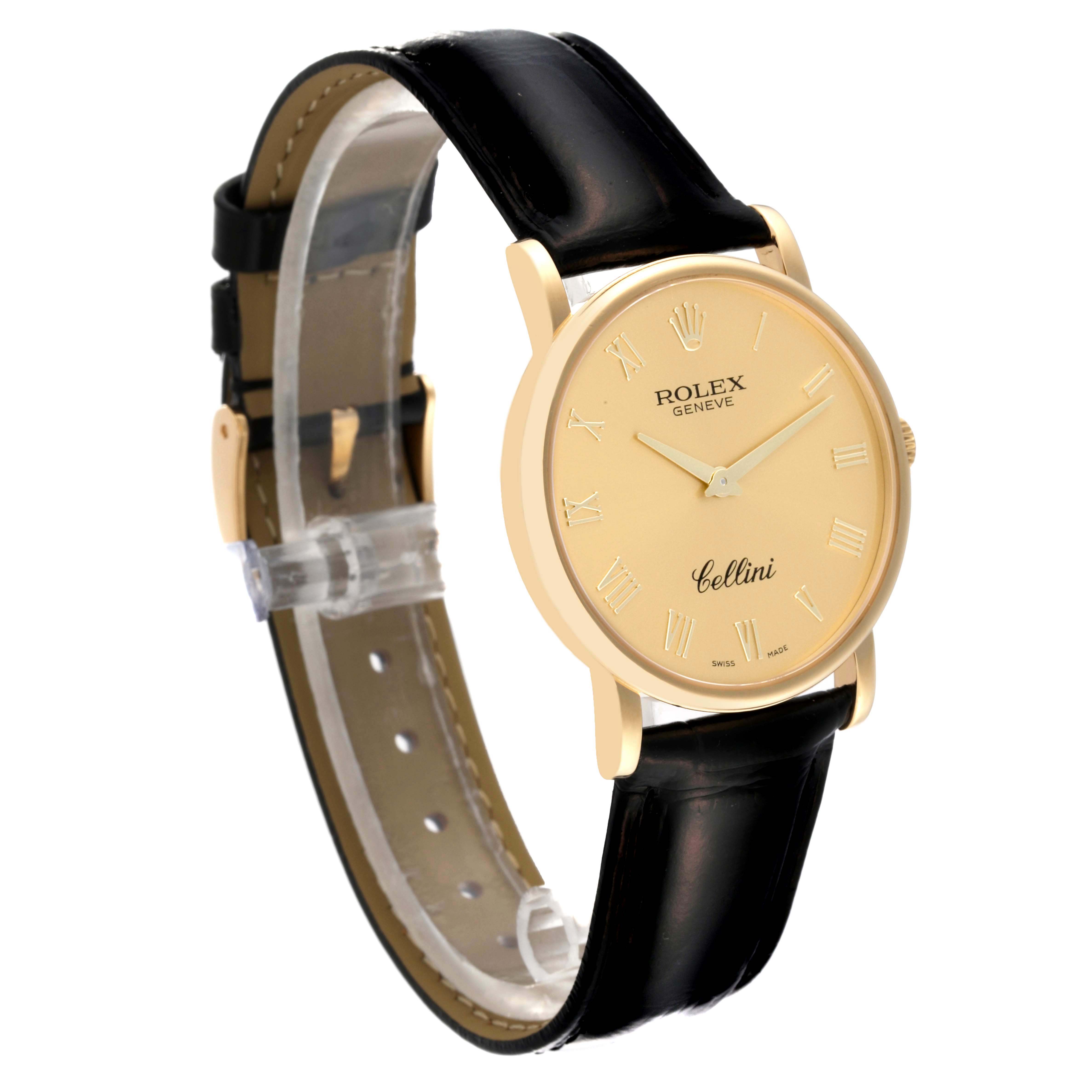 The Rolex Cellini 5115 Men's Yellow Gold Champagne Dial 5115 Men's Yellow Gold Champagne Dial watch is shown from a three-quarter angle, highlighting the gold case, dial, and black leather strap.