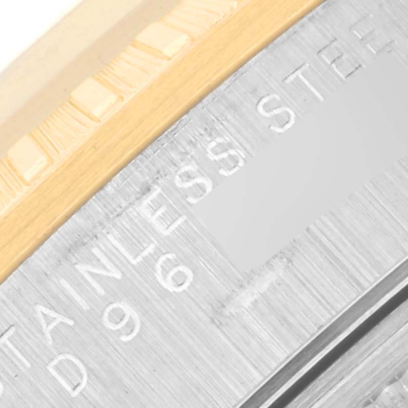 The image shows a close-up of the Rolex Date 15223 Men's Steel and Gold (two tone) Champagne Dial 15223 Men's Steel and Gold (two tone) Champagne Dial model, focusing on the bezel and engraved inner case markings.