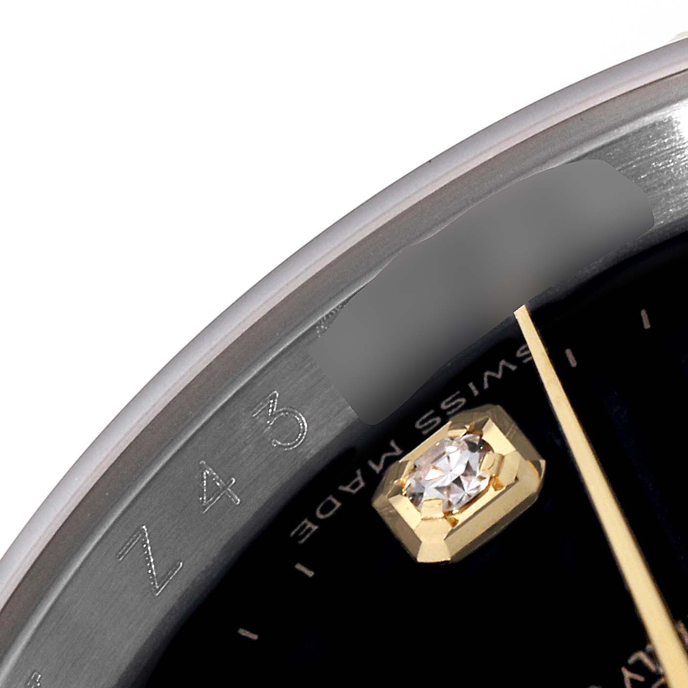 This close-up of the Rolex Datejust 116233 Men's Steel and Gold (two tone) Black Dial 116233 Men's Steel and Gold (two tone) Black Dial shows part of the dial, a gold hour marker with a diamond, and the edge of the bezel.