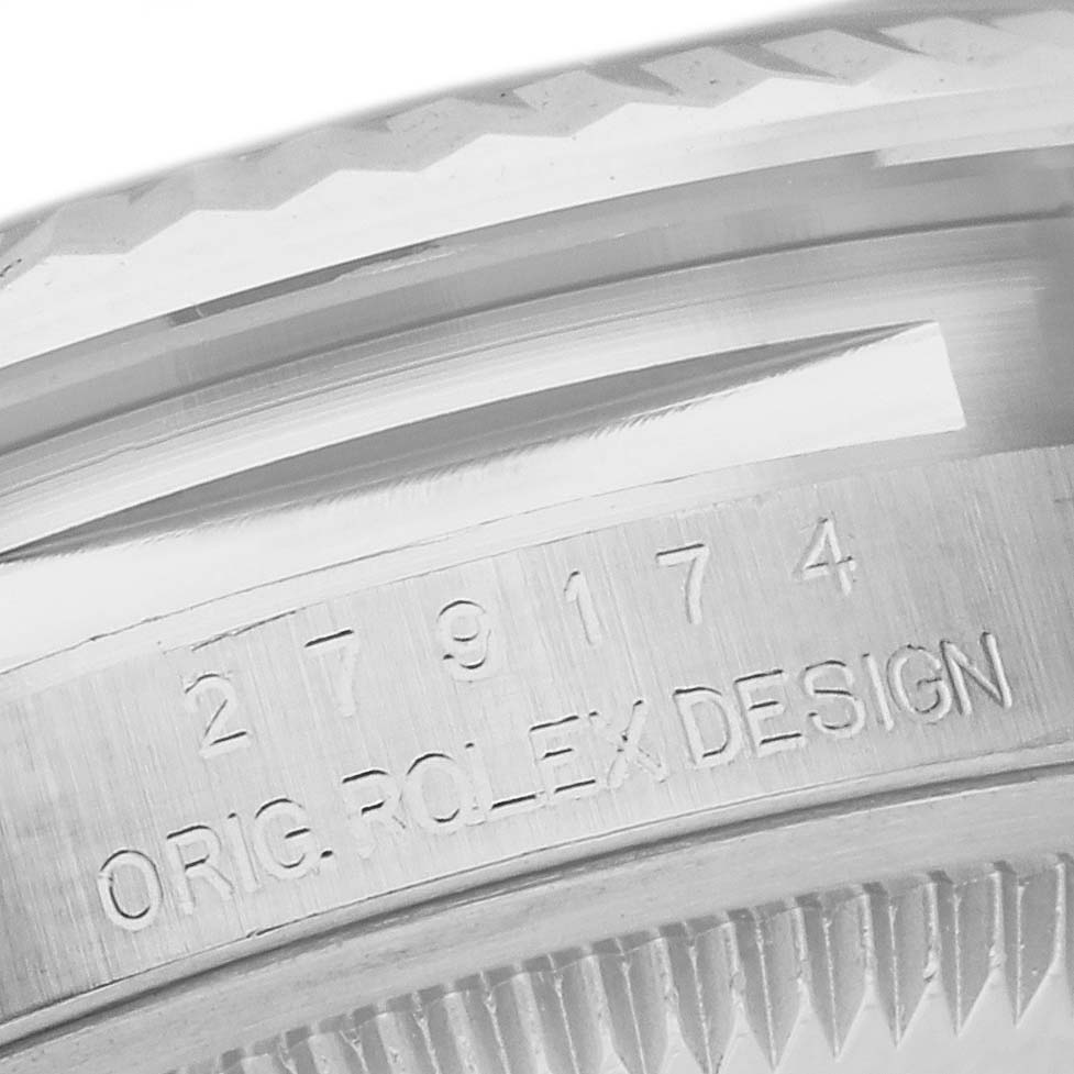 The image shows a close-up of the Rolex Datejust 279174 Women's Stainless Steel Pink Dial 279174 Women's Stainless Steel Pink Dial's engraved side and part of the fluted bezel.