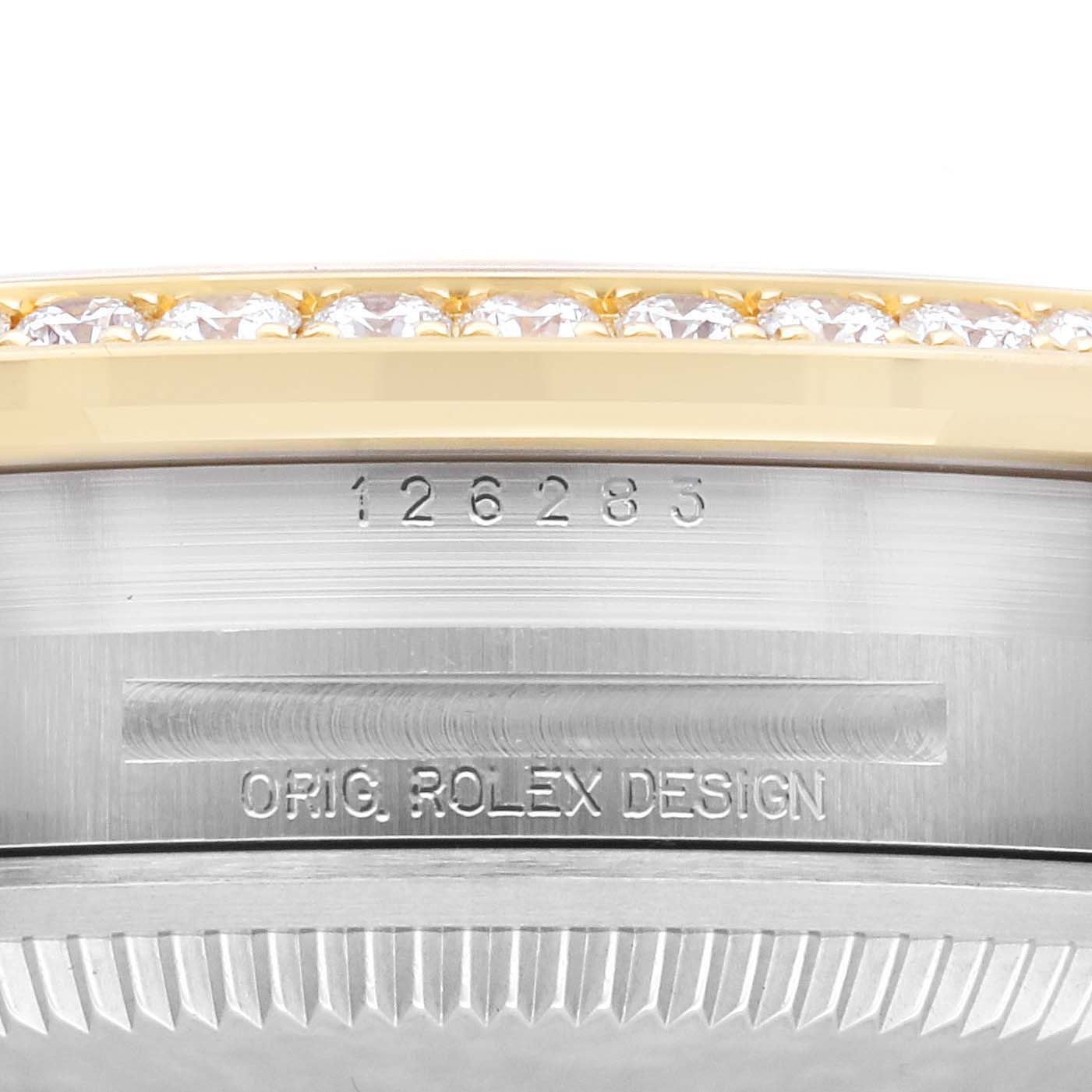 The image shows a close-up of the Rolex Datejust 126283 Men's Steel and Gold (two tone) Champagne Dial 126283 Men's Steel and Gold (two tone) Champagne Dial bezel with diamond accents and engraved details.