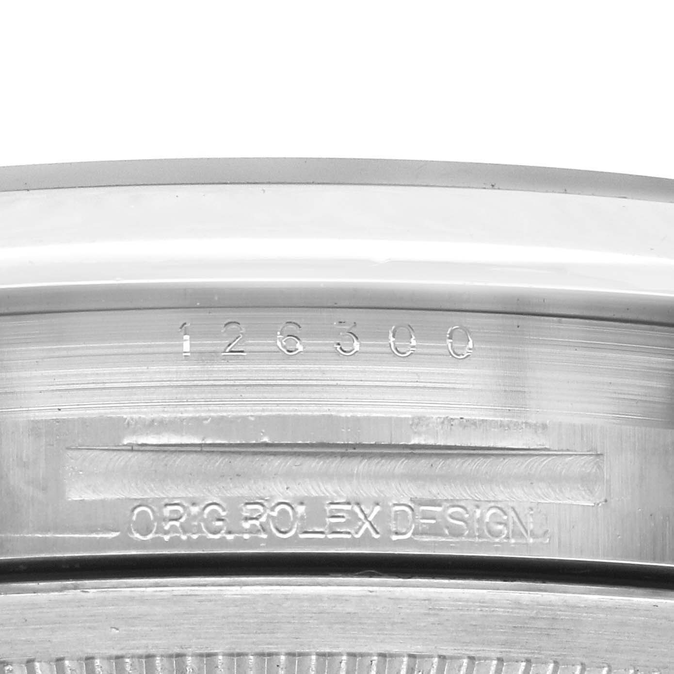 The image shows a close-up of the case edge with engraved serial number and "ORIG ROLEX DESIGN" on the Rolex Datejust 41 126300 Men
s Stainless Steel Blue Dial 126300 Men
s Stainless Steel Blue Dial.
