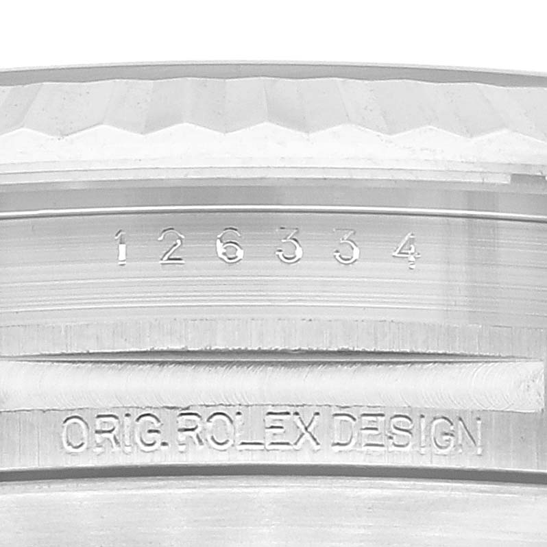 This close-up image shows the case side of the Rolex Datejust 41 126334 Men's Stainless Steel Blue Dial 126334 Men's Stainless Steel Blue Dial, highlighting its serial number and the engraving "ORIG. ROLEX DESIGN."